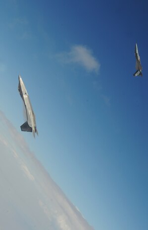 NELLIS AIR FORCE BASE, Nev.--An F-22A Raptor and F-15C Eagle from the U.S. Air Force Weapons School's 433rd Weapons Squadron pull into a vertical climb over the Nevada Test and Training Range July 16, 2010.  The NTTR is the U.S. Air Force’s premier military test and training facility with more than 12,000 square miles of airspace and 2.9 million acres of land. With 1,900 possible targets, realistic threat systems and the support of an opposing enemy force from Nellis Air Force Base, the NTTR provides the combat air force with a "peacetime battlefield" that cannot be replicated anywhere else in the world . (U.S. Air Force photo by Master Sgt. Kevin J. Gruenwald)

