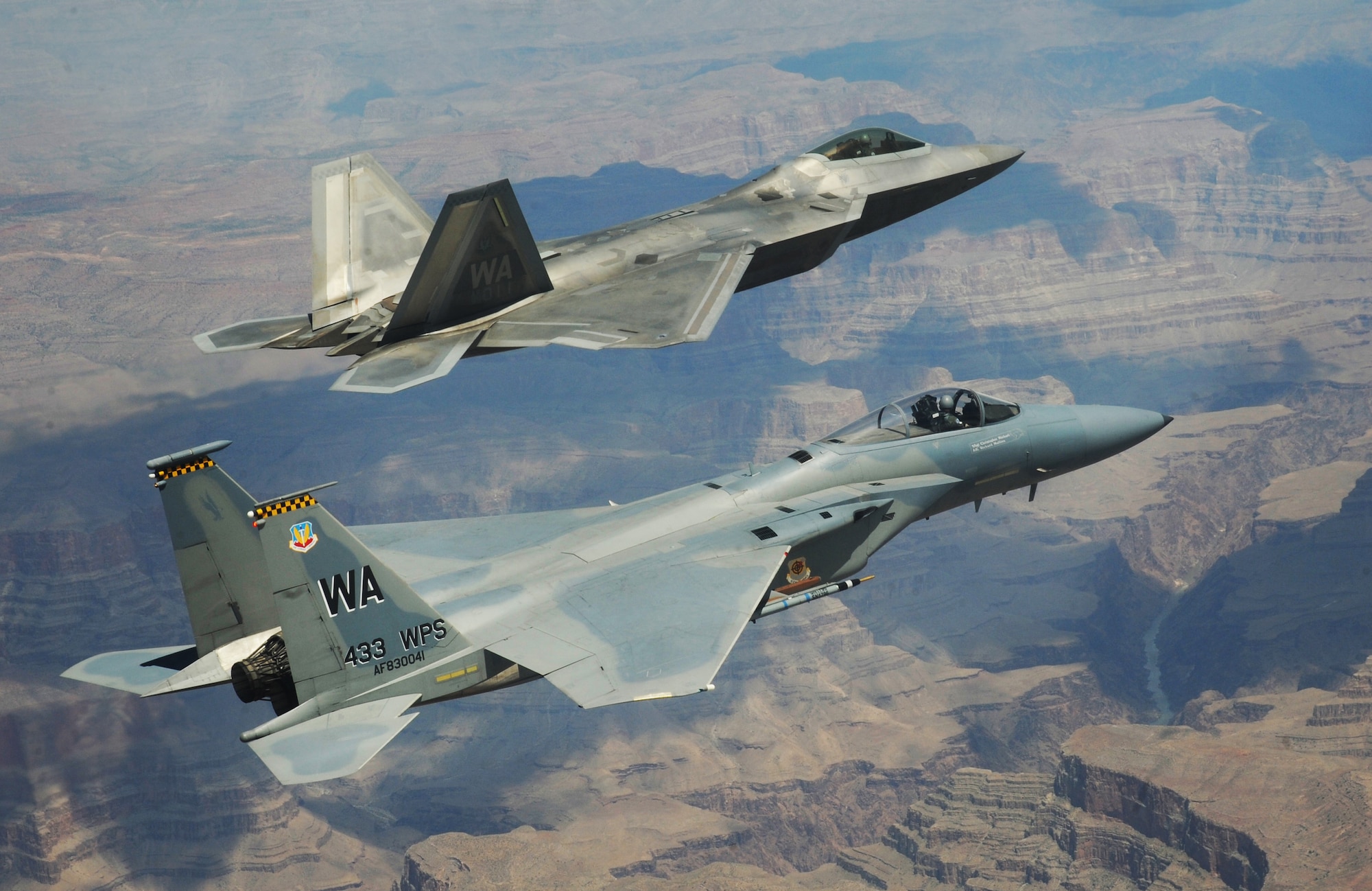 NELLIS AIR FORCE BASE, Nev.--An F-22A Raptor and F-15C Eagle from the U.S. Air Force Weapons School's 433rd Weapons Squadron fly in formation over the Grand Canyon, July 16, 2010.The Weapons School teaches graduate-level instructor courses that provide the world's most advanced training in weapons and tactics employment
(U.S. Air Force photo by Master Sgt. Kevin J. Gruenwald)

