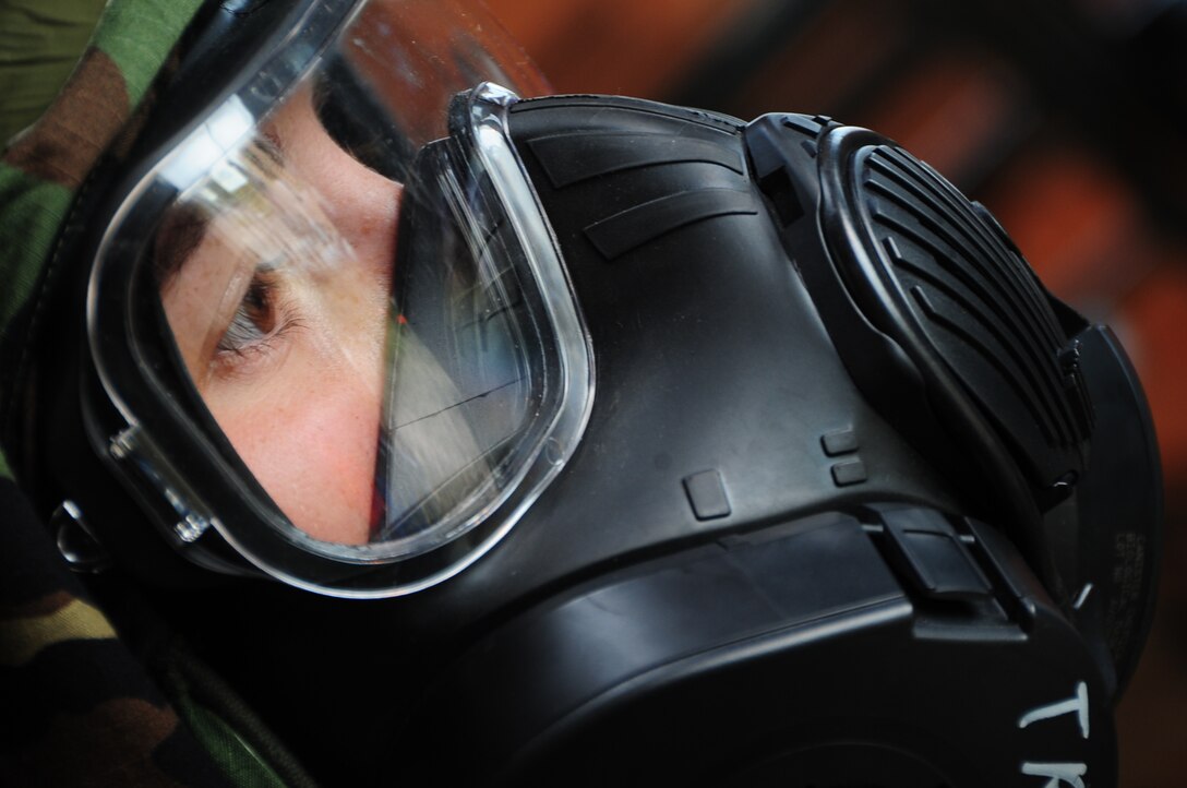 ELLSWORTH AIR FORCE BASE, S.D. -- Airman 1st Class Julie Kemps, 28th Medical Operations Squadron flight medicine technician, breathes through her gas mask during a phase II operational readiness exercise, July 21.  Airmen wear the gas mask during the phase II ORE as a means to improve their skills, should an actual attack occur while deployed. (U.S. Air Force photo/Airman 1st Class Anthony Sanchelli)
