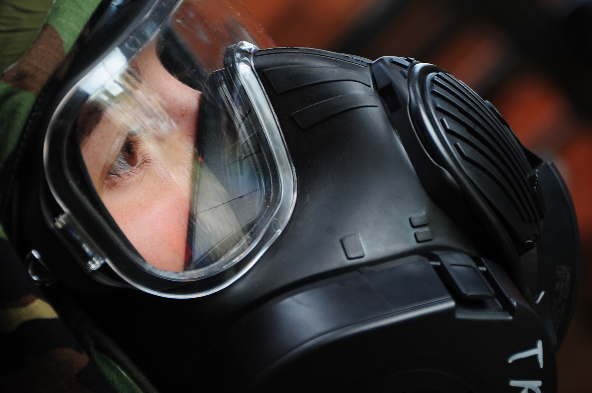 ELLSWORTH AIR FORCE BASE, S.D. -- Airman 1st Class Julie Kemps, 28th Medical Operations Squadron flight medicine technician, breathes through her gas mask during a phase II operational readiness exercise, July 21.  Airmen wear the gas mask during the phase II ORE as a means to improve their skills, should an actual attack occur while deployed. (U.S. Air Force photo/Airman 1st Class Anthony Sanchelli)
