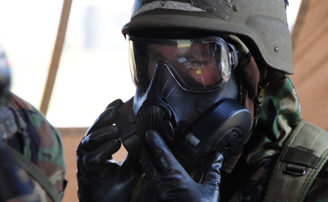 ELLSWORTH AIR FORCE BASE, S.D. -- Airman 1st Class John Henry, 28th Medical Operations Squadron ambulance services technician, checks his gas mask during a phase II operational readiness exercise, July 21.  The phase II ORE is designed to test Airmen in a simulated deployed environment. (U.S. Air Force photo/Airman 1st Class Anthony Sanchelli)
