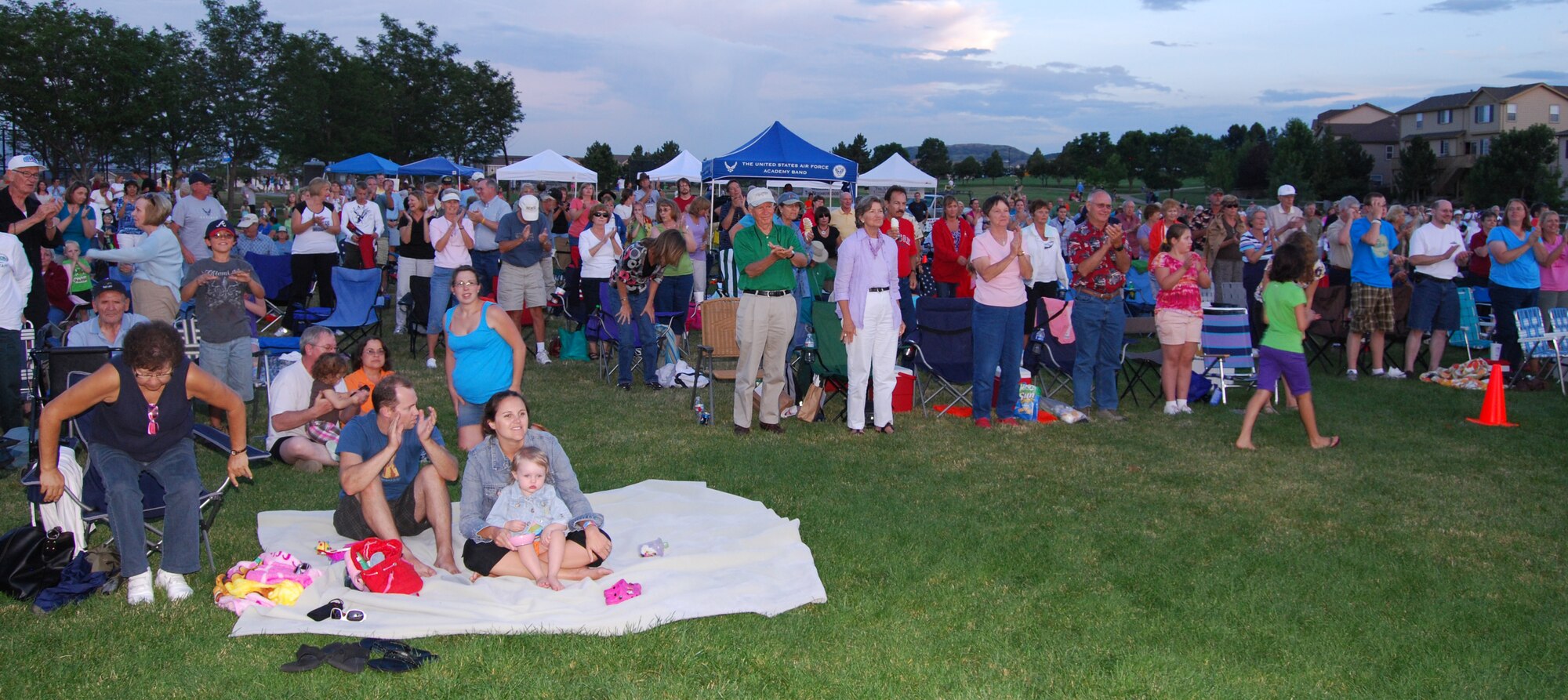 An appreciate audience gives a standing ovation at an outdoor performance of the USAF Academy Band at Butterfield Crossing Park in Castle Rock, CO.