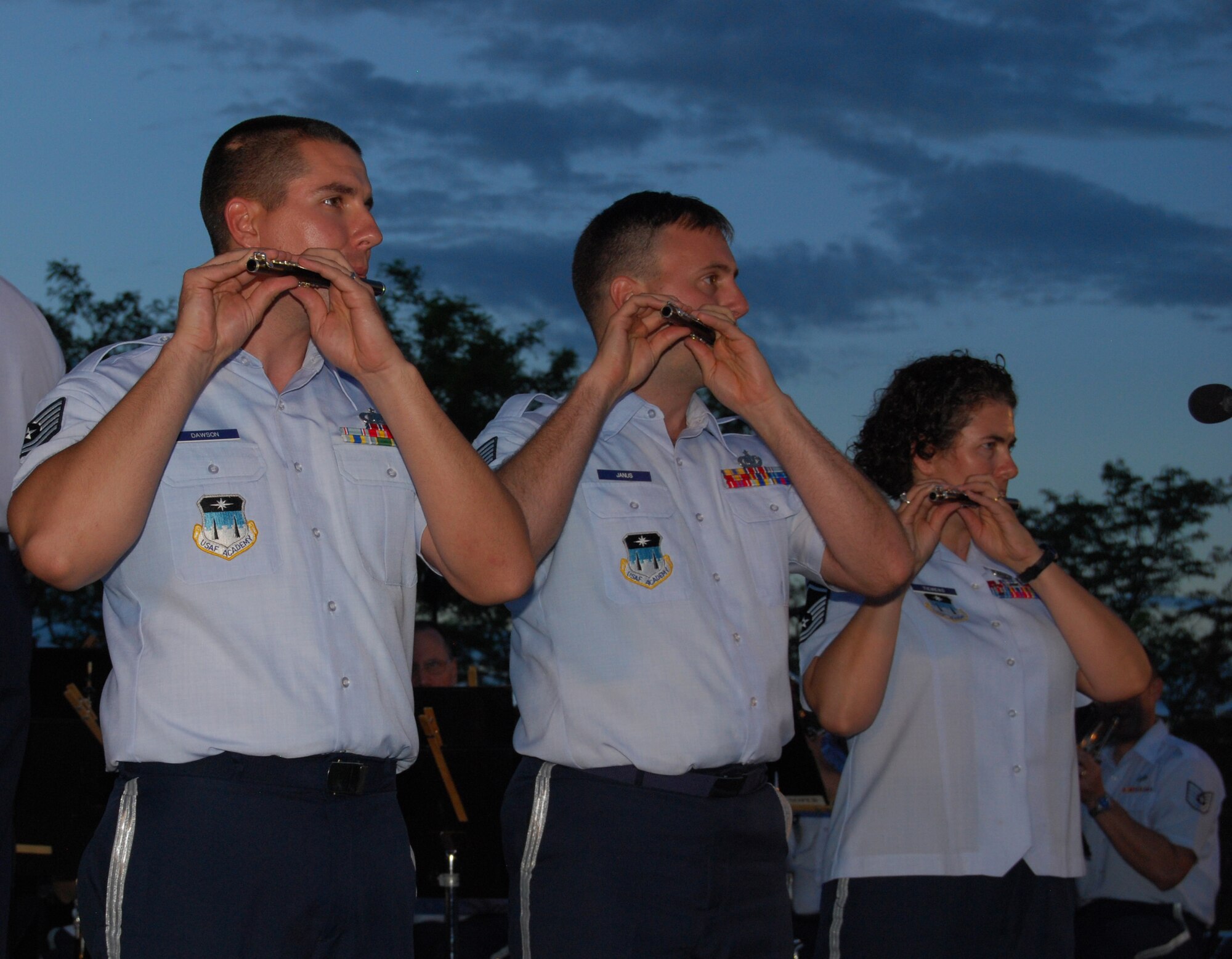 TSgts John Dawson and Ryan Janus, and MSgt Sandra Tiemens from the USAF Academy Band play the Piccolo solo from John P. Sousa's "The Stars and Stripes Forever" in the evening twilight at Butterfield Crossing Park in Castle Rock, CO.