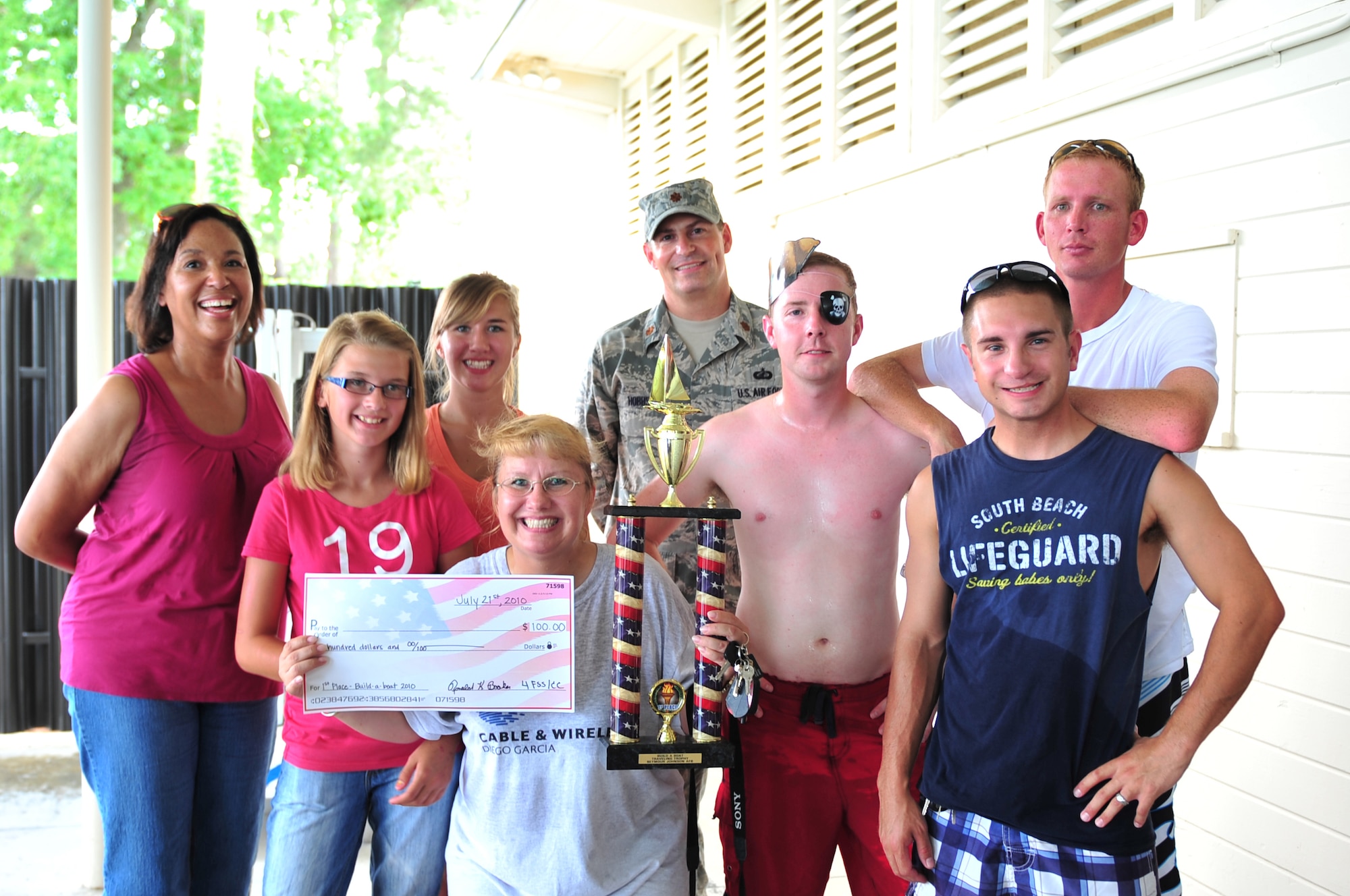 SEYMOUR JOHNSON AIR FORCE BASE, N.C. -- The 4th Contracting Squadron poses with the winner's trophy after completing the Build-A-Boat race in 49.2 seconds here, July 21, 2010. The winning team also received a check for $100 to use toward their holiday party. (U.S. Air Force photo/Senior Airman Rae Perry)