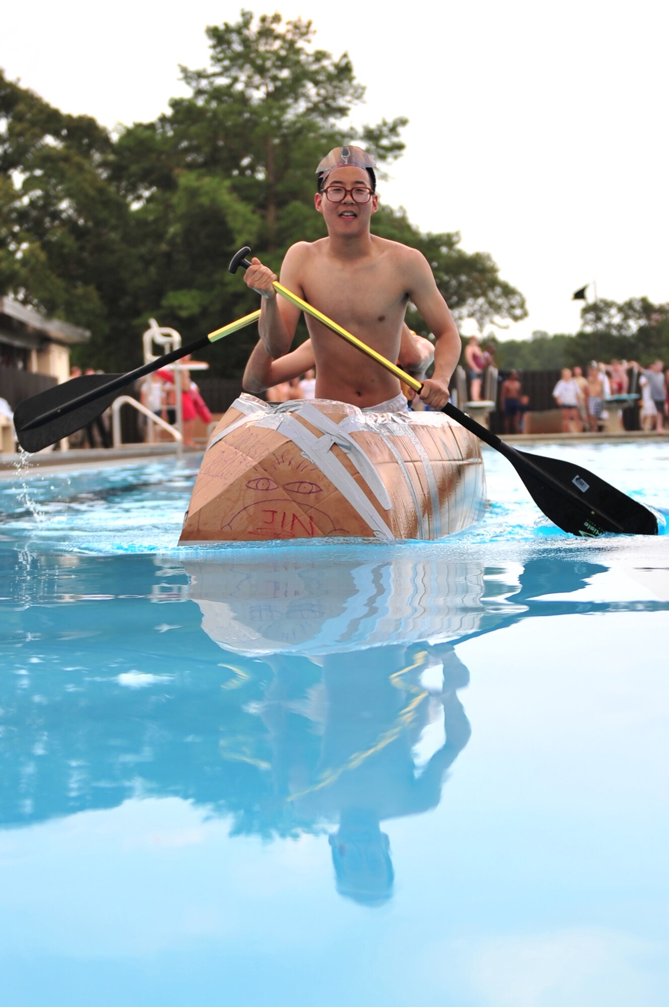 SEYMOUR JOHNSON AIR FORCE BASE, N.C. -- Senior Airman Jeffery Jin and Airman 1st Class Jordan Tatum row their boat the length of the Olympic Pool during a Build-A-Boat competition here, July 21, 2010. Ten teams came out to build their cardboard boats and show squadron pride. Airmen Jin and Tatum are members of the 4th Component Maintenance Squadron modular repair team one. Airman Jin is originally from Diamond Bar, Calif. Airman Tatum hails from Sandtown, Del. (U.S. Air Force photo/Senior Airman Rae Perry)