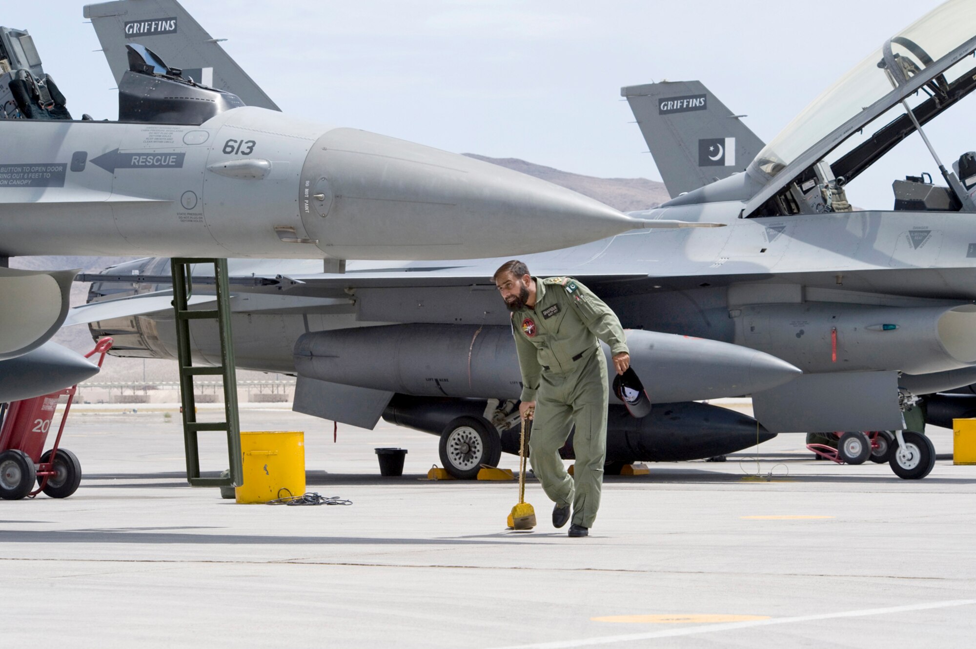 A Pakistan air force crew chief chalks an F-16 upon arrival for a Red Flag exercise July 16, 2010, at Nellis Air Force Base, Nev. The team stopped at Lajes Field, Azores,  July 14 through15 to refuel and bed down their crew before heading to Nellis AFB. This is the Pakistan air force's first time participating in Red Flag. (U.S. Air Force photo/Lawrence Crespo)