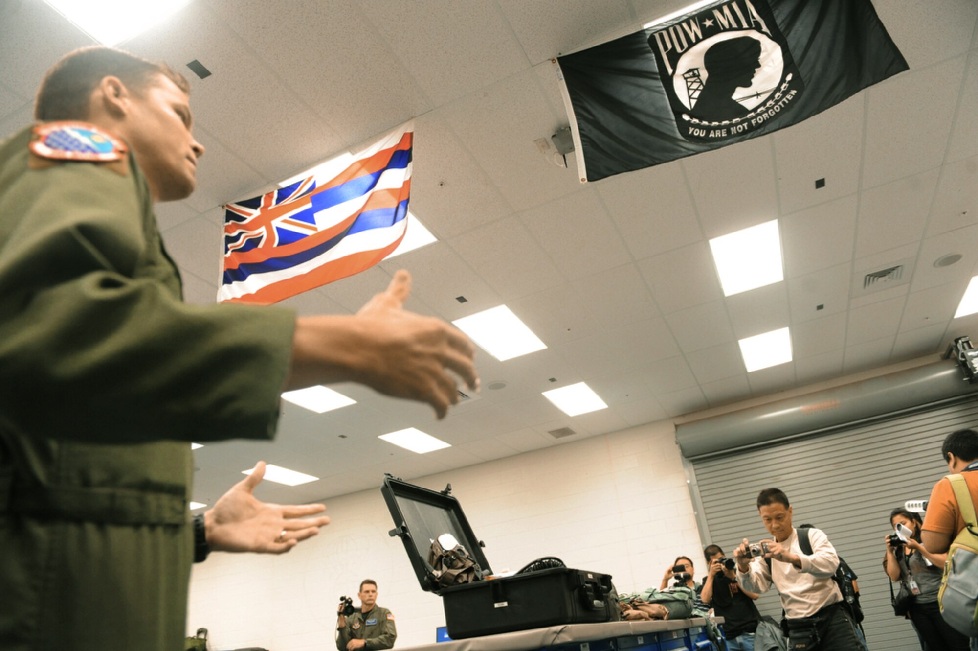 Capt. Chris Keller briefs local bloggers about the duties of the Airmen who work in the life support section of the 535th Airlift Squadron before the group's ride aboard a C-17 Globemaster III to watch an Improved Container Delivery Systems air drop July 16, 2010, over the Island of Hawaii. The air drop was conducted to show the bloggers the capabilities Pacific Air Forces during the Rim of the Pacific 2010 exercise. (U.S. Air Force photo/Tech Sgt. Cohen A. Young)