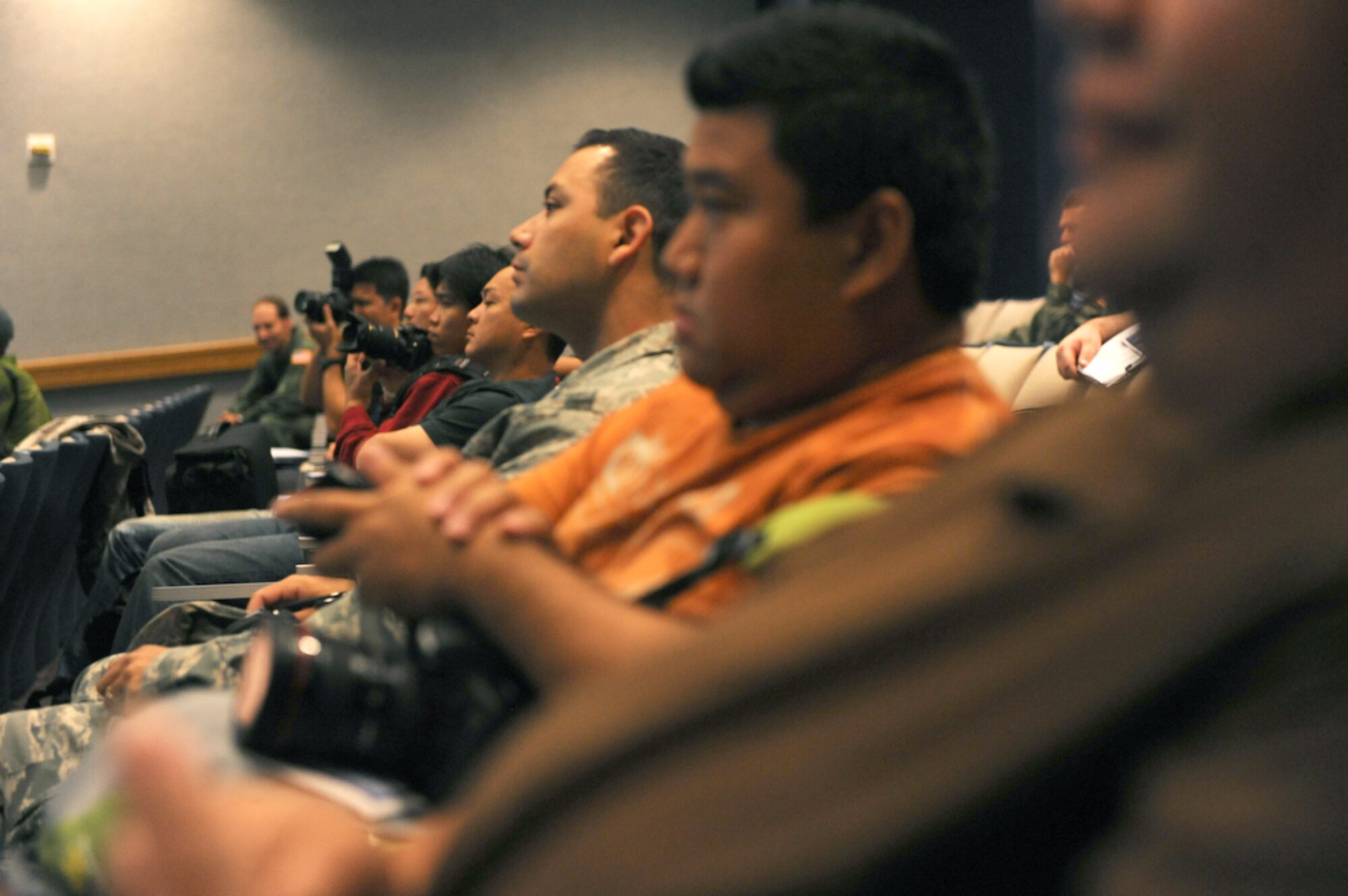 Bloggers listen to a briefing July 16, 2010, at the 535th Airlift Squadron at Joint Base Pearl Harbor-Hickam Hawaii. Pacific Air Forces and the 535th AS officials, invited local bloggers to view an air drop first hand during the Rim of the Pacific Exercise. RIMPAC is the largest maritime exercise in the world and comprises participants from 14 nations, 32 ships, five submarines, more than 170 aircraft and 20,000 personnel. (U.S. Air Force photo/Tech Sgt. Cohen A. Young)