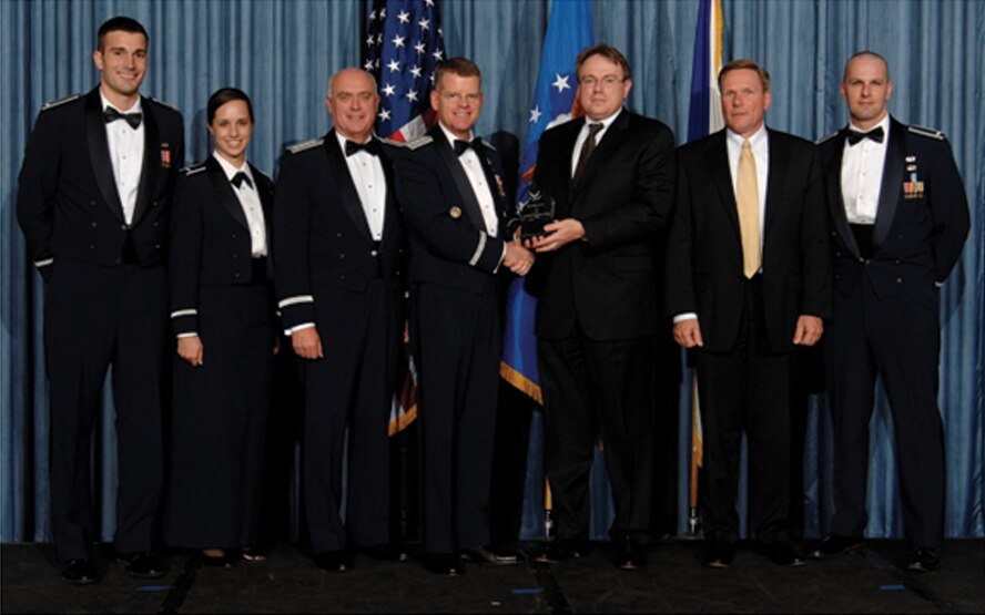 Several members of the Improved Flash-Bang Grenade team accept the Air Force 2009 Science, Technology, Engineering, and Mathematics award for Outstanding Scientist Team during the STEM awards ceremony.  (AF photo by Mike Kaplan)