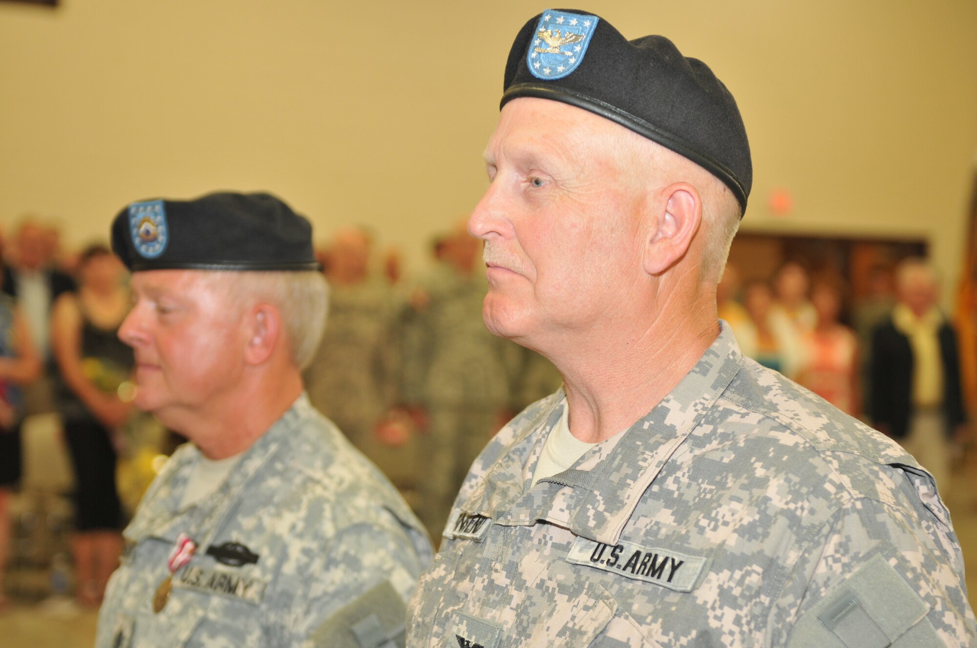 Col. Steven Bensend, right, listens to the reading of the orders awarding his Meritorious Service Medal as Command Sgt. Major Ed Hansen, already pinned with his medal, stands by his side. The medals were awarded during a change-of-command ceremony at Camp Williams July 10. Wisconsin National Guard photo by Tech. Sgt. Jon LaDue