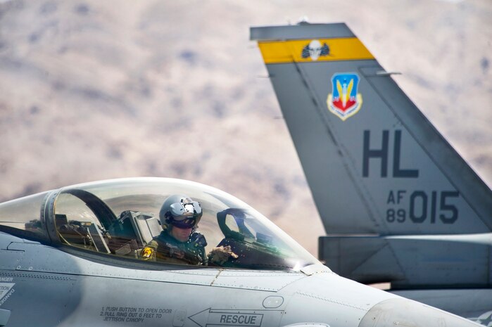 NELLIS AIR FORCE BASE, NEV.-- Capt. Mike Seltzer, pilot, 4th Fighter Squadron, Hill Air Force Base, sets cockpit switches on his F-16 prior to take off during Green Flag-West 10-8 held at Nellis, July 20.  Green Flag-West is where U.S. Air Force, joint, and coalition aircrews hone their air-land integration skills for success in our current operations. (US Air Force Photo by Lawrence Crespo)