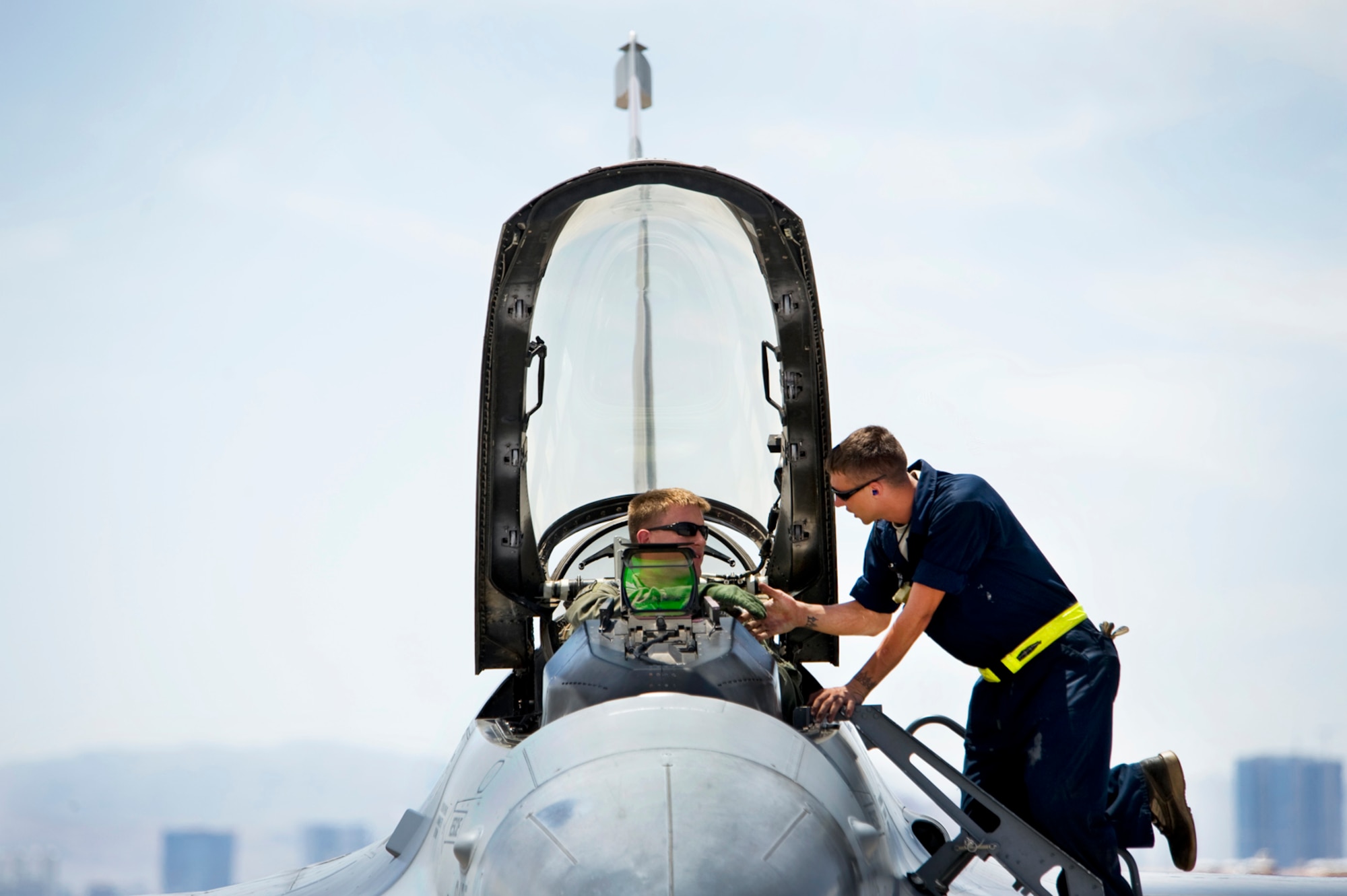 NELLIS AIR FORCE BASE, Nev.-- Senior Airmen Jorge Schweitzer, crew chief, shakes Capt. Paul Doughty hand as he wishes him a safe flight prior to closing the aircraft canopy. Both Airmen assigned to the 388th Fighter Wing, Hill Air Force Base. Their wing is participating in Green Flag-West 10-8 held at Nellis on July 20. The exercise provides a realistic air-land integration training environment for Airmen and Soldiers preparing to deploy in support of worldwide combat operations.(US Air Force Photo by Lawrence Crespo)
