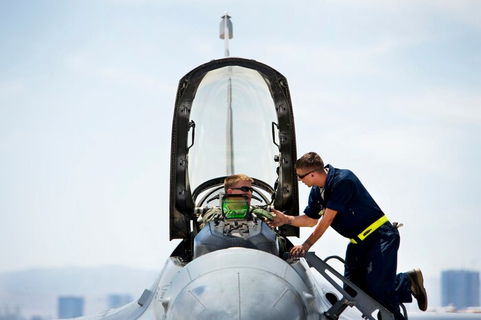 NELLIS AIR FORCE BASE, Nev.-- Senior Airmen Jorge Schweitzer, crew chief, shakes Capt. Paul Doughty hand as he wishes him a safe flight prior to closing the aircraft canopy. Both Airmen assigned to the 388th Fighter Wing, Hill Air Force Base. Their wing is participating in Green Flag-West 10-8 held at Nellis on July 20. The exercise provides a realistic air-land integration training environment for Airmen and Soldiers preparing to deploy in support of worldwide combat operations.(US Air Force Photo by Lawrence Crespo)
