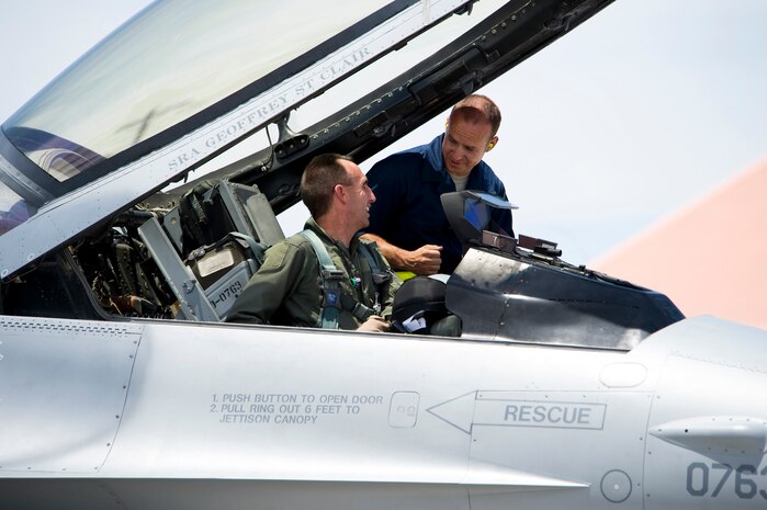 NELLIS AIR FORCE BASE, Nev.-- Tech. Sgt. Jonathon Peck, 388th Maintenance Operations Squadron assist Col. Scott Zobrist, commander, 388th Fighter Wing into his F-16 during Green Flag West 10-8 held at Nellis on July 20, 2010. 

Col. Zobrist led his wing team during the Green Flag training exercise. The wing is training with U.S. Army Soldiers in a realistic air-land integration training environment in  preparation for deployment in support of worldwide combat operations. (US Air Force Photo by Lawrence Crespo)
