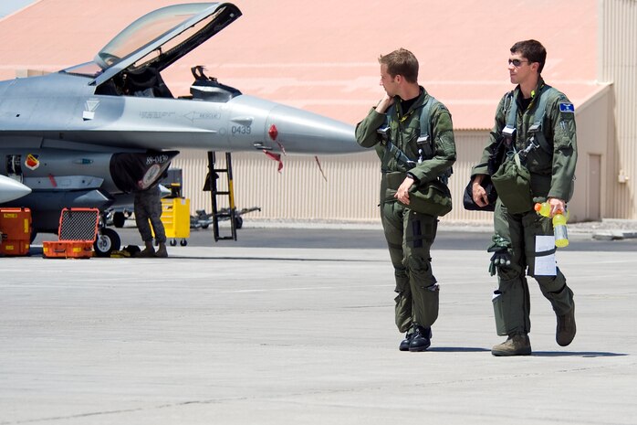 NELLIS AIR FORCE BASE, Nev.-- Capt. Phil Jackson and Capt. J.R. Gibbens, F-16 pilots assigned to the 4th Fighter Squadron, Hill Air Force Base, Utah, walk to their aircraft prior to a Green Flag mission July 20, 2010.  Both pilots are participating in Green Flag-West 10-8 held at Nellis July 9-23.  The exercise provides a realistic air-land integration training environment for Airmen and Soldiers preparing to deploy in support of worldwide combat operations. (US Air Force Photo by Lawrence Crespo)
