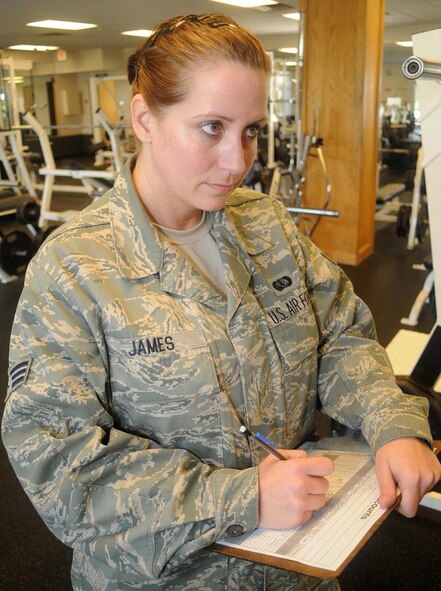 Senior Airman Kelly James, a fitness specialist with the 512th Memorial Affairs Squadron, Dover Air Force Base, Del., performs a safety and inventory check at the fitness center here June 6. Airman James said she likes working in the fitness center and helping Airmen reach their true fitness potential. (U.S. Air Force photo/Senior Airman Bhawan P. Singh)