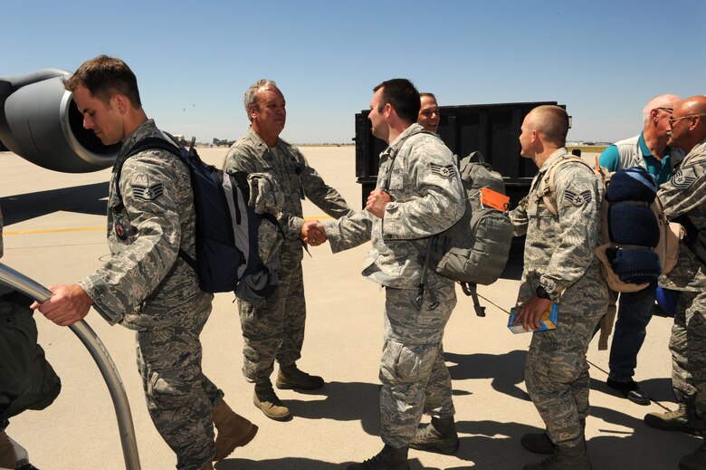 Idaho Air Guard leaders shake hands with members of the 124th Civil Engineer Squadron and 124th Communications Flight board a KC-135 bound at Gowen Field in Boise, Idaho for Vares, Bosnia-Herzegovina for a two-week deployment that will upgrade a local school's electricity and Internet connectivity.