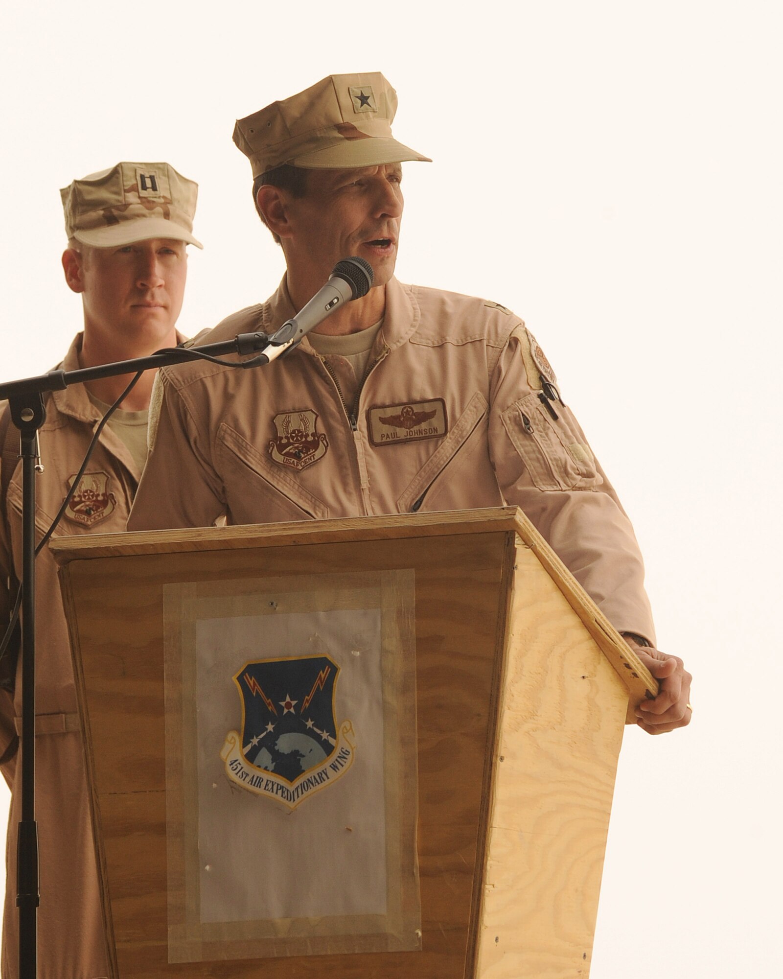 Brig. Gen. Paul Johnson, 451st Air Expeditionary Wing commander, addresses Airmen during a change-of-command ceremony at Kandahar Airfield, Afghanistan, July 21, 2010.  Afghan Airmen hosted the ceremony at the Afghan Air Force hangar to showcase the partnership between the Kandahar Air Wing and the 451 AEW.    (U.S. Air Force Photo by Staff Sgt. Chad Chisholm/Released)