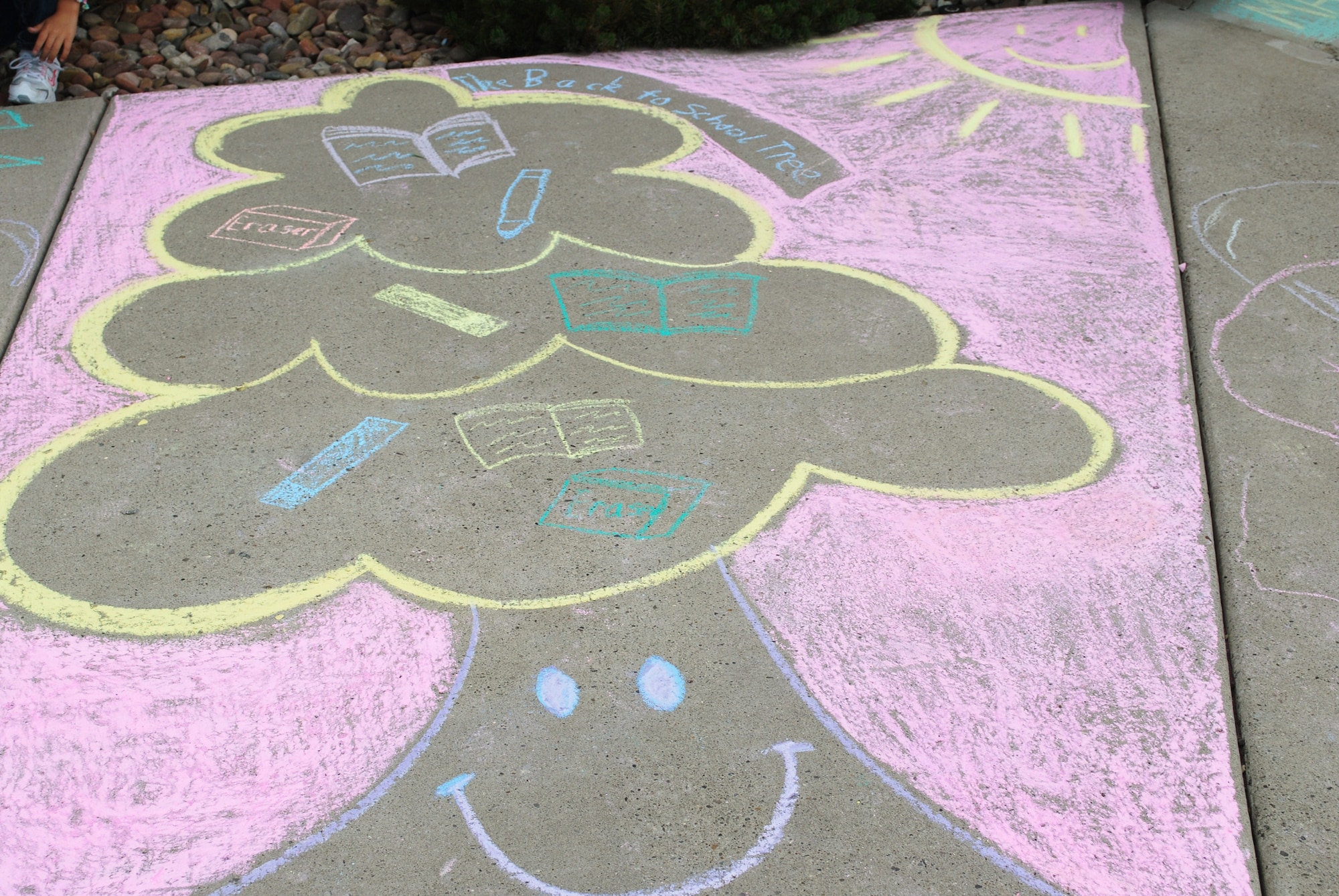 The Douglas family drew a “Back to School Tree” for their contribution to the annual Chalk-it-Up! competition. Family teams were given a sidewalk square to create their masterpieces on outside of the base Youth Center.