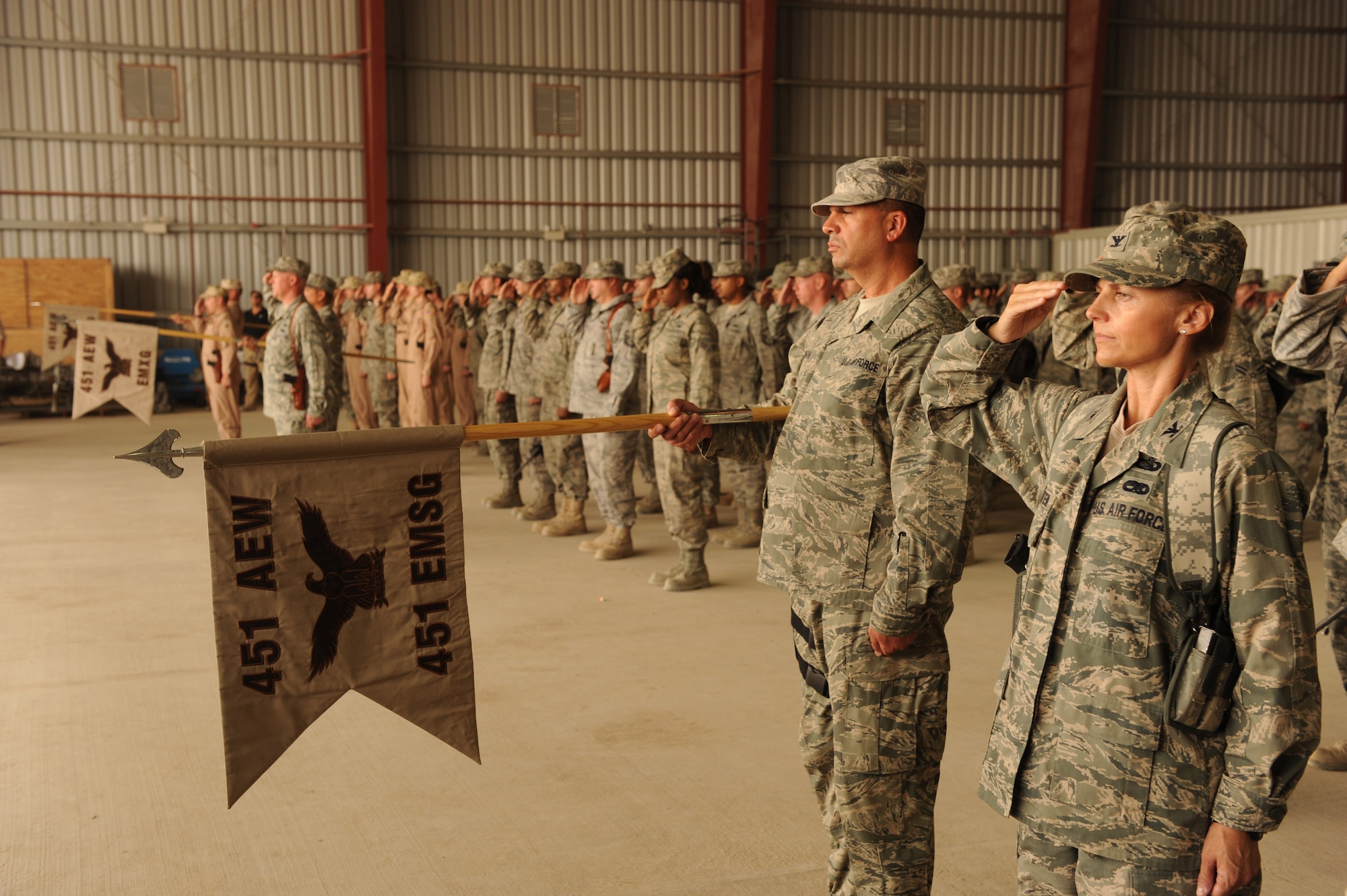 Members of the 451st Air Expeditionary Wing salute during a change-of-command ceremony at Kandahar Airfield, Afghanistan, July 21, 2010.  Brig. Gen. Paul Johnson, 451 AEW commander, assumed command during the ceremony, hosted by the Kandahar Air Wing at the Afghan Air Force hangar.    (U.S. Air Force Photo by Staff Sgt. Chad Chisholm/Released)
