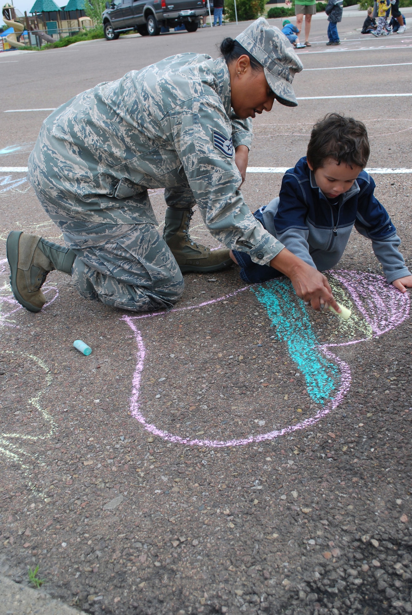 Staff Sgt. Digna May, 341st Force Support Squadron classification and duty status non-commissioned officer in charge, helps her son Tharen, 4, shade in a heart that they drew for the competition. (U.S. Air Force photo/Airman 1st Class Kristina Overton) 