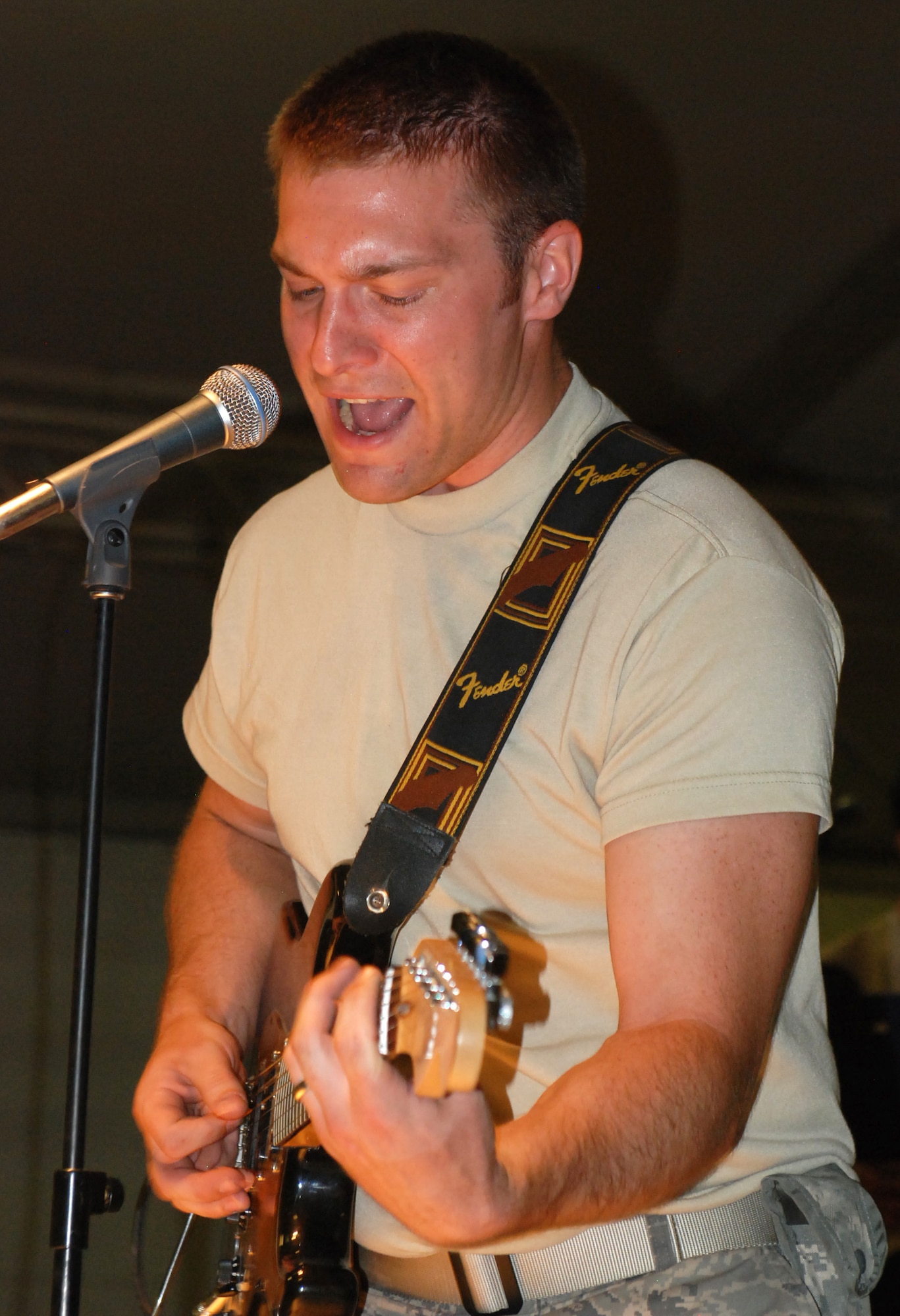 Staff Sgt. Brian McNally of the Air Force Central Command band High Altitude covers “Plush” by the Stone Temple Pilots in the Fest Tent at Kandahar Air Field. During High Altitude's first deployment to the CENTCOM area of operations, the band belted out a mix of classic rock and pop hits for coalition forces stationed in Kandahar. (U.S. Navy photo by Chief Petty Officer Brian Brannon / Released)