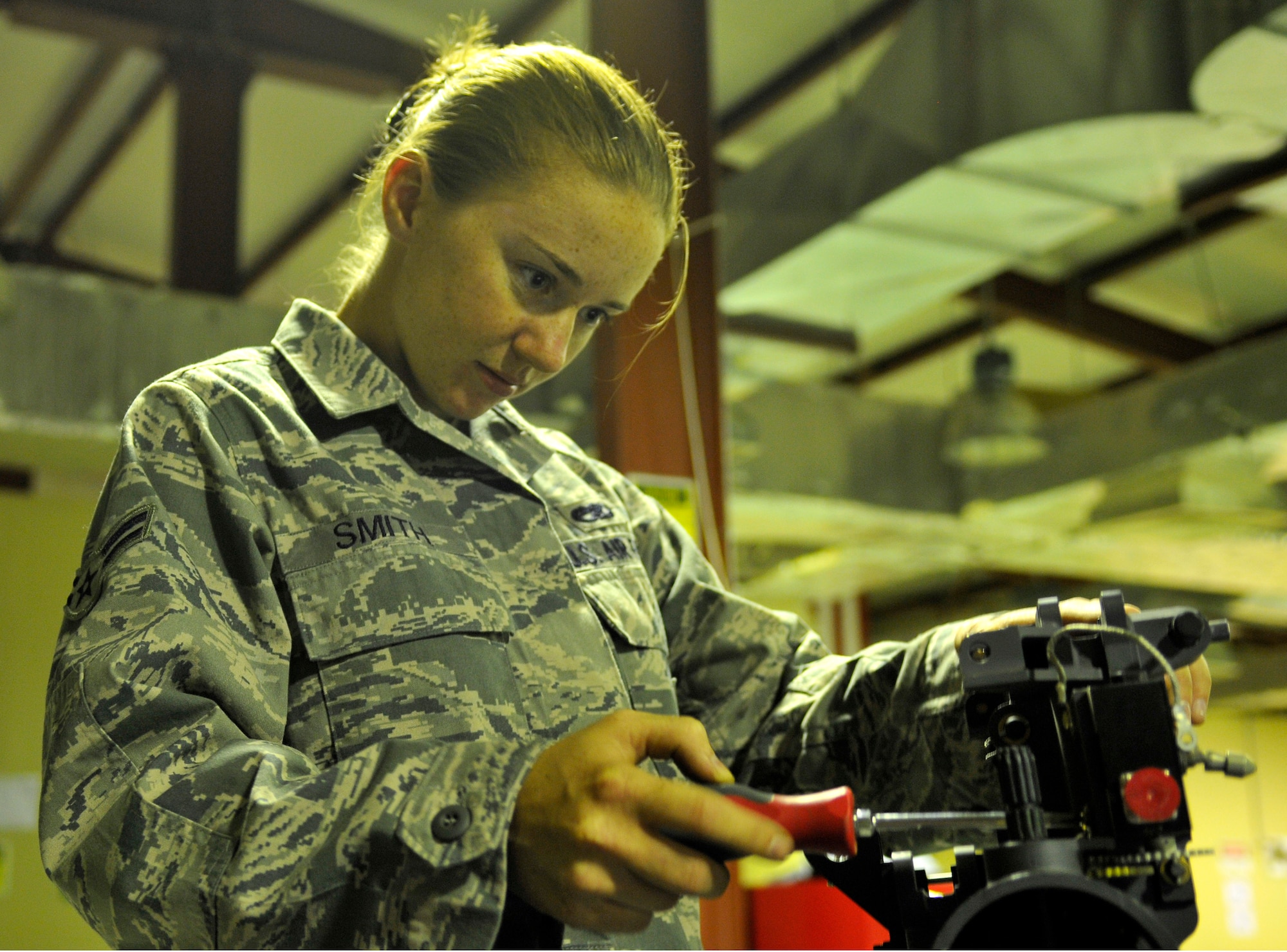 Airman 1st Class Laura Smith, 332nd Expeditionary Maintenance Squadron aircraft armament technician, removes the rounds-limit switch on a M-61A1 20mm multi-barrel cannon due to sticking numbers July 17, 2010, Joint base Balad, Iraq. The M-61A1 is capable of firing at a rate of 6,000 rounds a minute. Airman Smith is a native of Whiteville, N.C., deployed from Shaw Air Force Base, S.C. (Air Force photo/Staff Sgt. Phillip Butterfield)