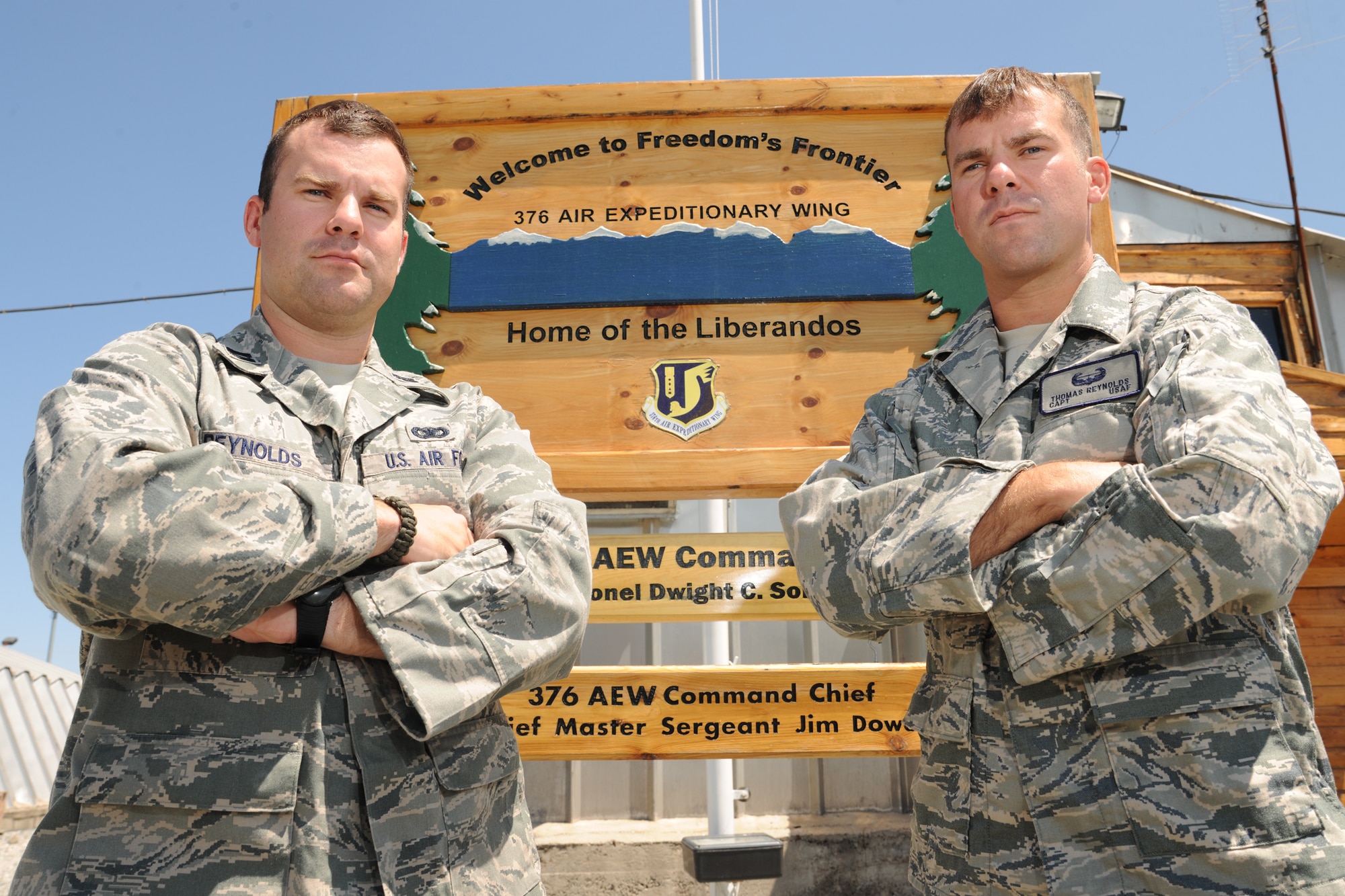 TRANSIT CENTER AT MANAS, Kyrgyzstan - Capt. Taylor Reynolds (left), here for six months with the 376th Expeditionary Security Forces Squadron deployed from Aviano Air Base, Italy, poses with his twin brother July 22.  Capt. Thomas Reynolds, from the 20th Logistics Readiness Squadron at Shaw Air Force Base, S.C., is forward deploying for one year to become a combat advisor to Afghan National Police, Kabul, Afghanistan.  This is the first time the brothers have crossed paths during a deployment and have not seen each other since August 2008.  (U.S. Air Force photo/Staff Sgt. Nathan Bevier)