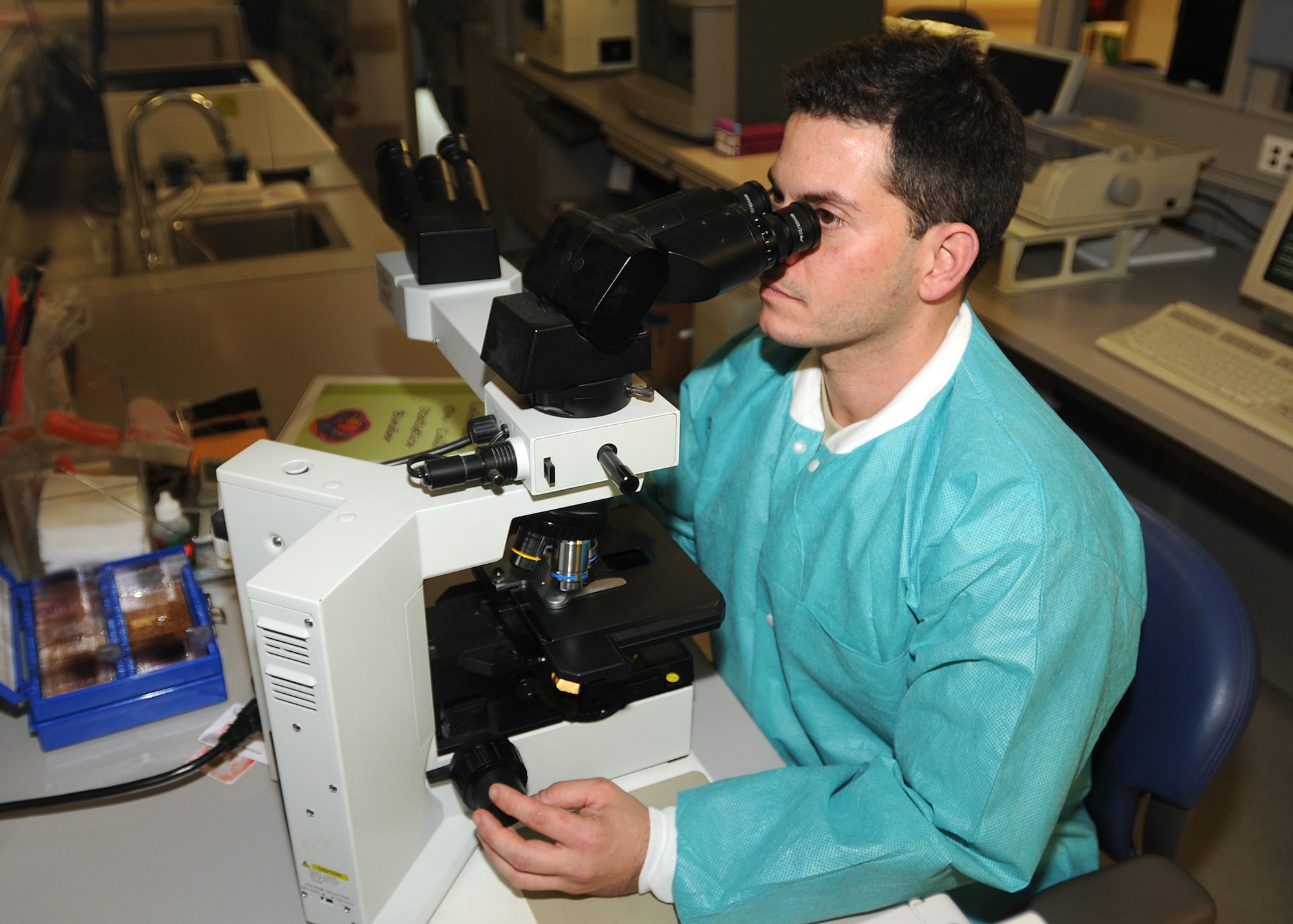Tech. Sgt. Deryk Espina, 31st Medical Support Squadron noncommissioned officer in charge of hematology section, examines blood cells through a microscope July 20 at the medical laboratory.  Blood examination helps doctors provide diagnosis on a patient?s condition.  (U.S. Air Force photo/Senior Airman Tabitha M. Lee)
