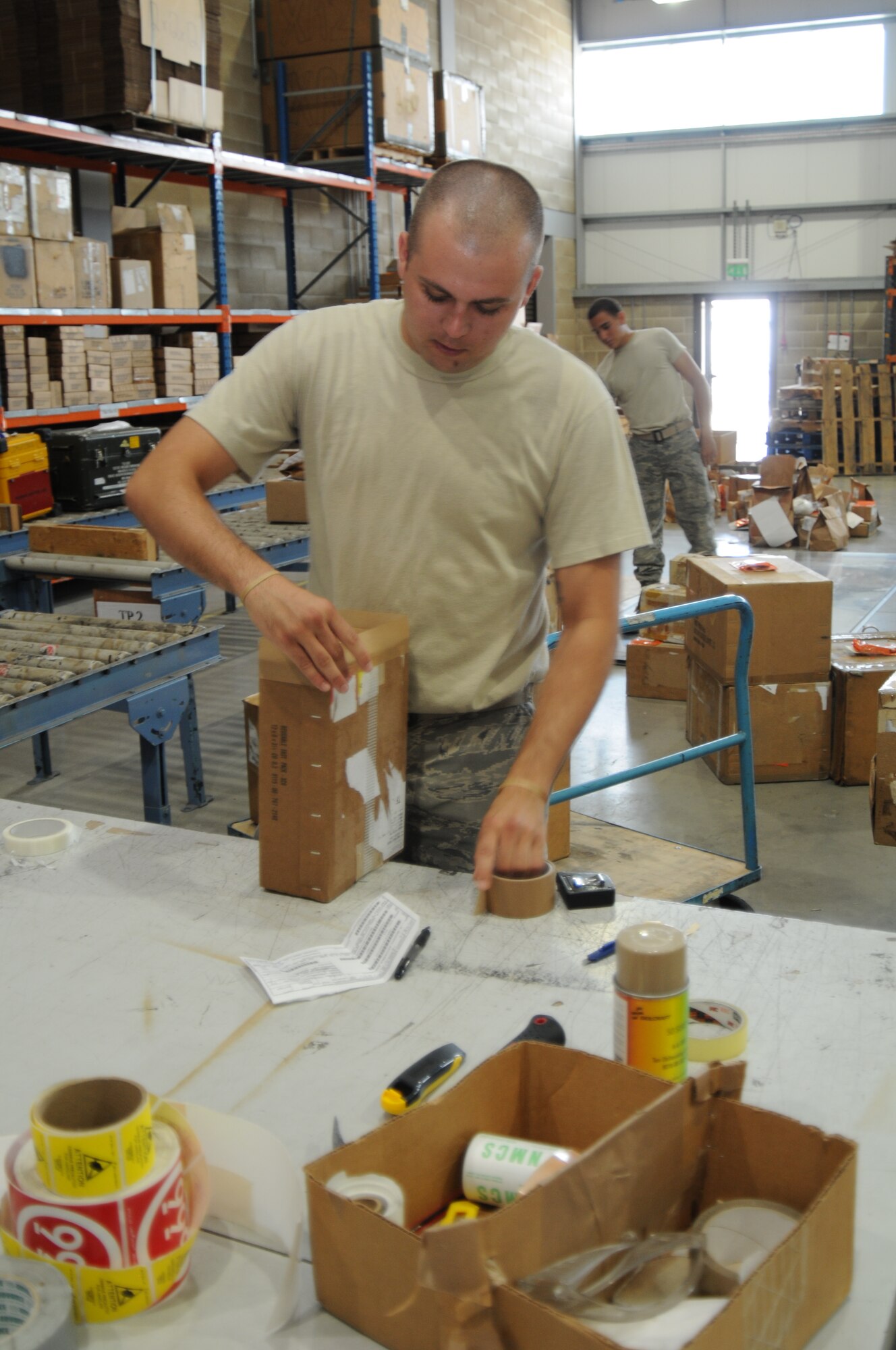 Senior Airman Robert Lee, 45th Logistics Readiness Squadron traffic management journeyman, prepares a package for shipment in the TMO warehouse July 19. TMO processes 150-200 separate items daily. (U.S. Air Force photo/Senior Airman David Dobrydney)