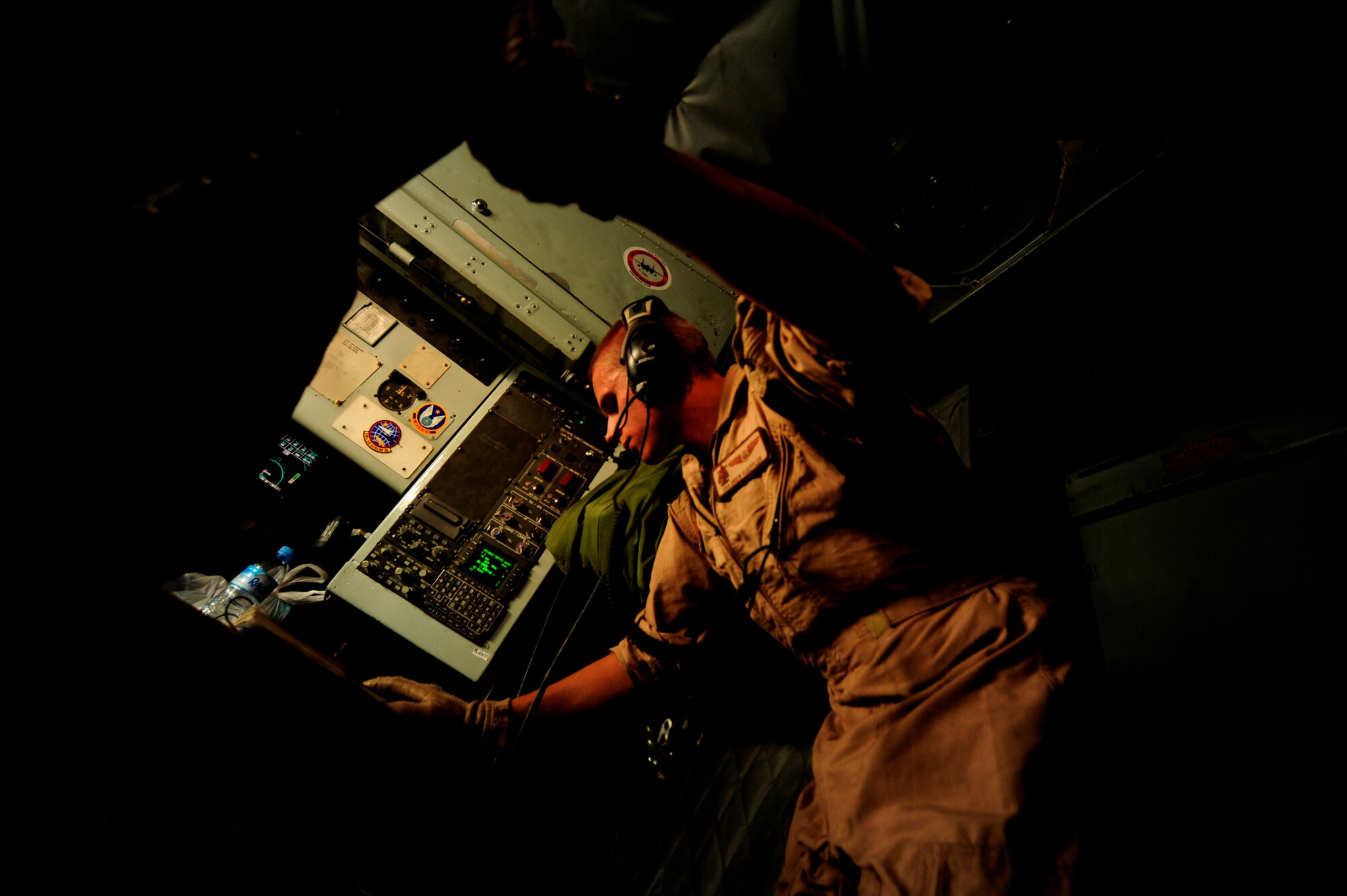 U.S. Air Force Senior Airman Andrew Kueffler, a KC-135 Stratotanker boom operator assigned to the 340th Expeditionary Air Refueling Squadron, talks with pilots finalizing pre-flight checks during a flying mission over Afghanistan while deployed to a base in Southwest Asia on July 8, 2010. Coalition tankers have flown greater than 6,000 sorties, offloaded greater than 400 million pounds of fuel and refueled nearly 33,000 aircraft as of June 30, 2010. (U.S. Air Force photo by Staff Sgt. Andy M. Kin / Released)