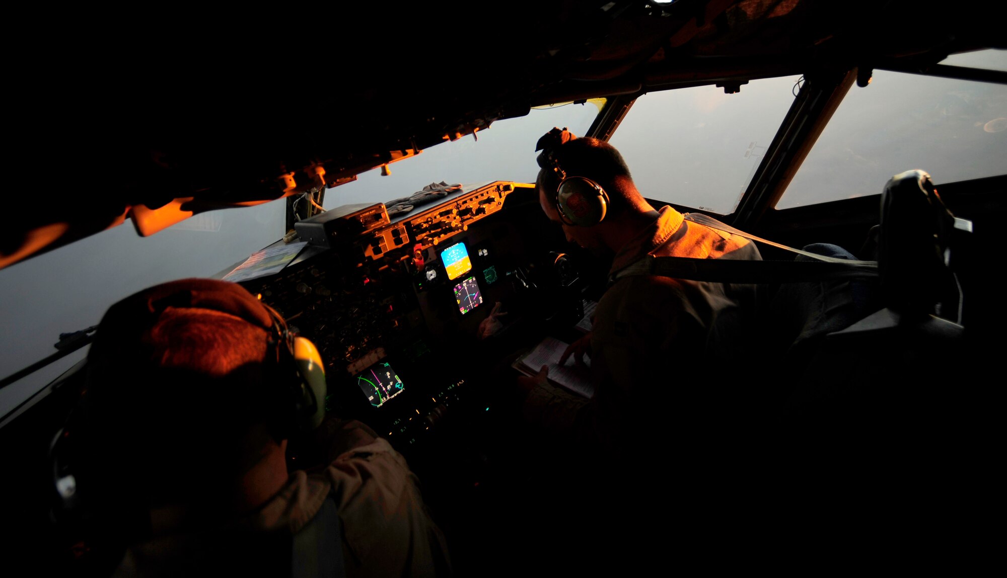 U.S. Air Force Captains Adam Kornitzer, left, and Nicholas Williams, KC-135 Stratotanker pilots assigned to the 340th Expeditionary Air Refueling Squadron, perform checks and stay on course during a refueling mission of a U.S. Marine Corps F-18 Hornet on July 8, 2010. Coalition tankers have flown greater than 6,000 sorties, offloaded greater than 400 million pounds of fuel and refueled nearly 33,000 aircraft as of June 30, 2010. (U.S. Air Force photo by Staff Sgt. Andy M. Kin / Released)