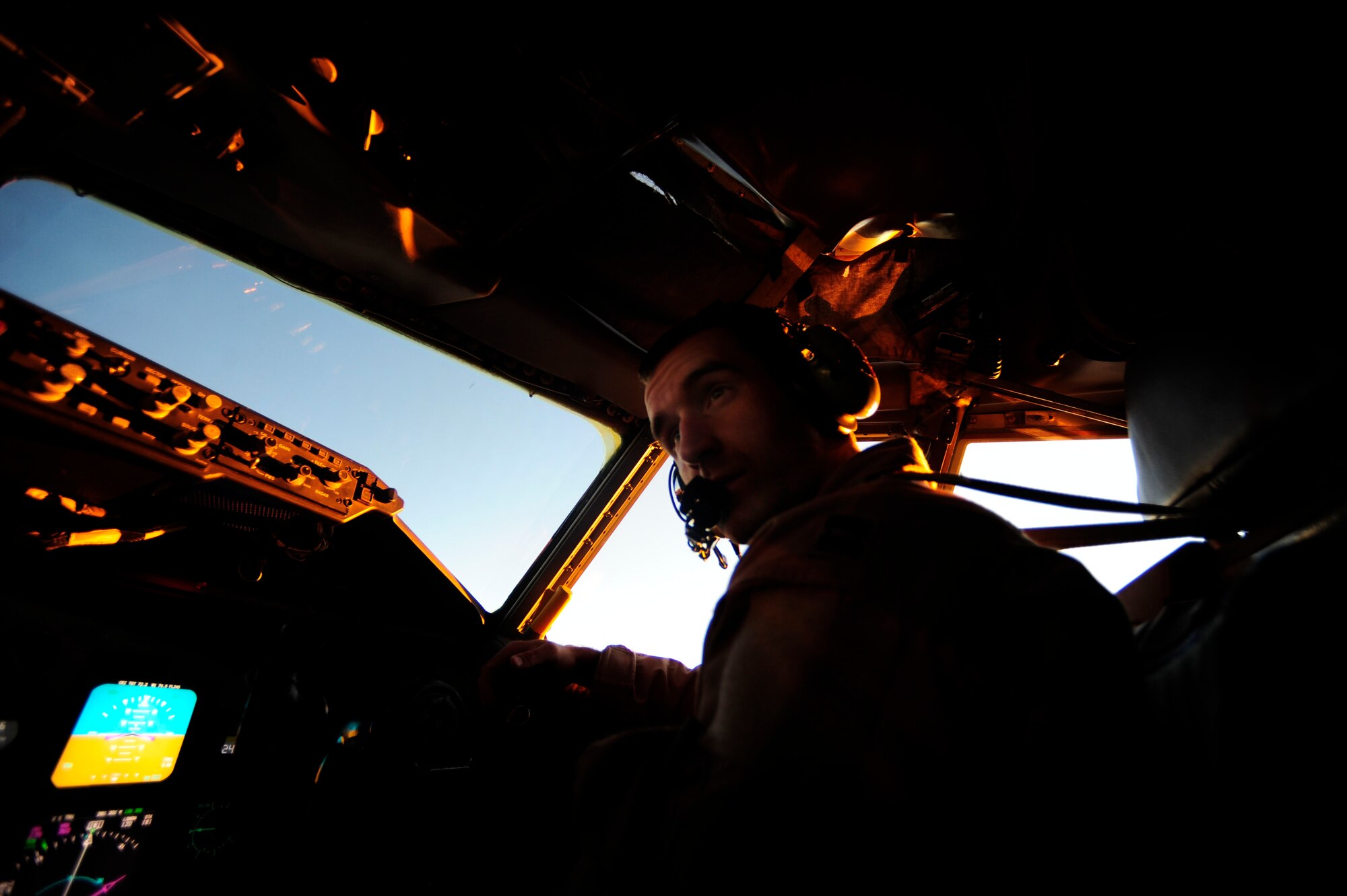 U.S. Air Force Capt. Nicholas Williams, a KC-135 Stratotanker pilot assigned to the 340th Expeditionary Air Refueling Squadron, communicates with his pilot for confirmation during a flying mission while deployed to a base in Southwest Asia on July 8, 2010. Coalition tankers have flown greater than 6,000 sorties, offloaded greater than 400 million pounds of fuel and refueled nearly 33,000 aircraft as of June 30, 2010. (U.S. Air Force photo by Staff Sgt. Andy M. Kin / Released)