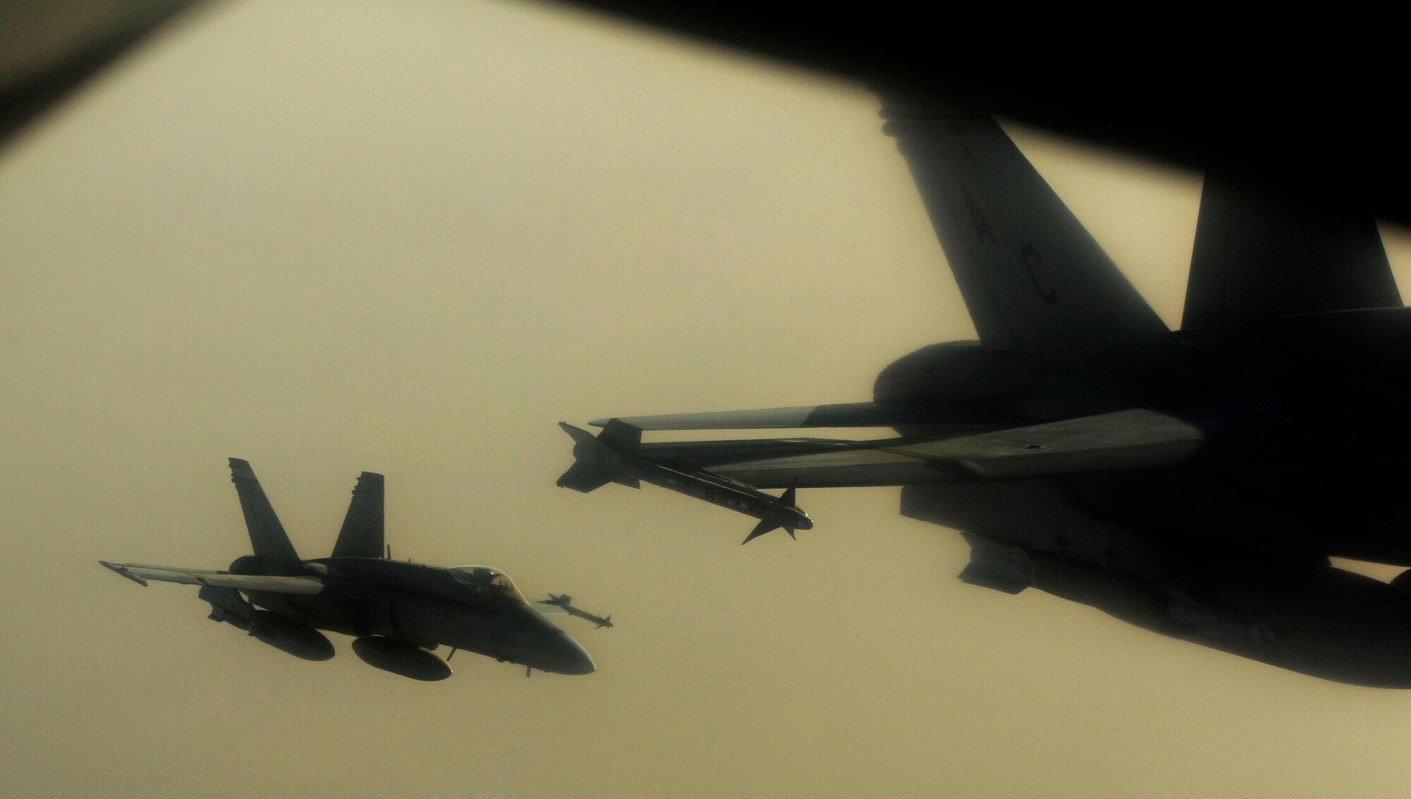 U.S. Marine Corps F-18 Hornets refuel with a KC-135 Stratotanker assigned to the 340th Expeditionary Air Refueling Squadron over Afghanistan on July 8, 2010. The 340th EARS is deployed to a base in Southwest Asia. Coalition tankers have flown greater than 6,000 sorties, offloaded greater than 400 million pounds of fuel and refueled nearly 33,000 aircraft as of June 30, 2010. (U.S. Air Force photo by Staff Sgt. Andy M. Kin / Released)