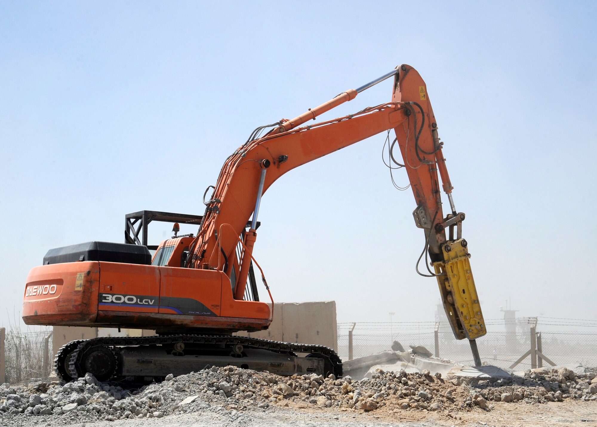 A jackhammer crane crushes pieces of a concrete barrier into smaller pieces at the 332nd Expeditionary Civil Engineer Squadron Contract Management Flight crushing site, July 2, 2010, at Joint Base Balad, Iraq. Deteriorated or damaged barriers are crushed and recycled for road construction, erosion and dust control projects. (U.S. Air Force photo/ Senior Airman Matt Coleman-Foster)