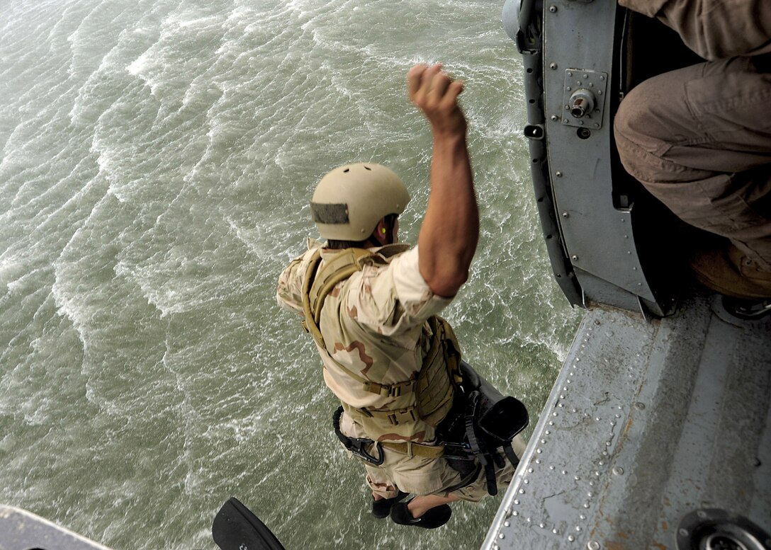 A U.S. Navy SEAL leaps from a helicopter as part of a capabilities exercise held during the annual SEAL/Underwater Demolition Team reunion on Joint Expeditionary Base Little Creek-Fort Story in Virginia Beach, Va., July 17, 2010.