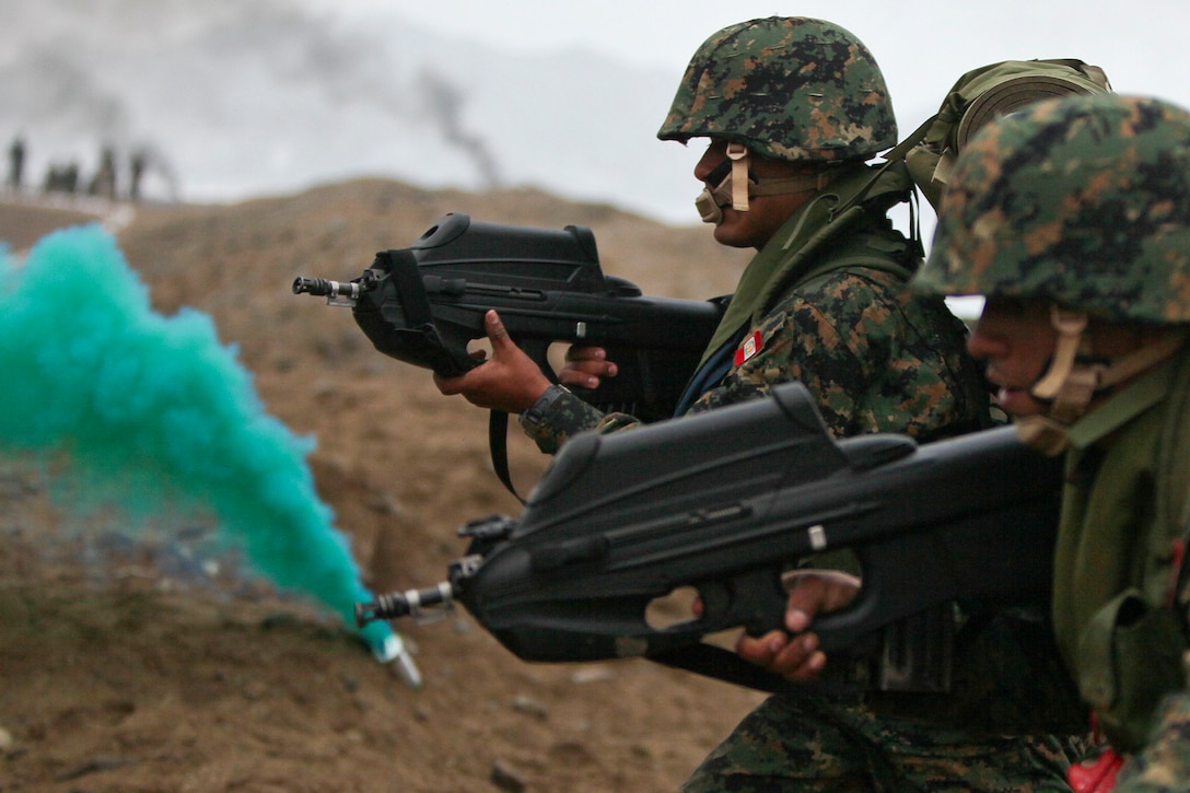Peruvian marines carry F2000 assault rifles during a Partnership of the America's Southern Exchange exercise on a beach with troops from 10 nations in Ancon, Peru, July 19, 2010. 