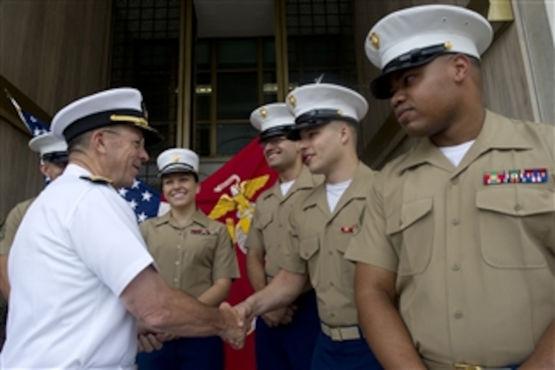 Chairman of the Joint Chiefs of Staff Adm. Mike Mullen, U.S. Navy, greets U.S. Marines assigned to the embassy in New Delhi, India, on July 22, 2010.  India is the second stop on a 10-day around the world trip meeting counterparts and leaders.  