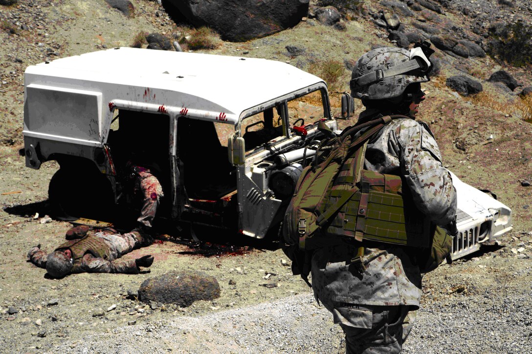 Marines from Combat Logistics Battalion 3, rush to aid four simulated casualties inside a Humvee mangled by a simulated improvised explosive device during an Enhanced Mojave Viper pre-deployment training evolution at MCAGCC Twentynine Palms, July 15. The Marines didn’t know the casualties were actually civilian amputees and actors used to make the training more realistic.