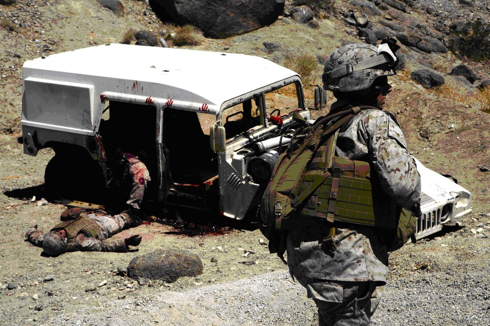 Marines from Combat Logistics Battalion 3, rush to aid four simulated casualties inside a Humvee mangled by a simulated improvised explosive device during an Enhanced Mojave Viper pre-deployment training evolution at MCAGCC Twentynine Palms, July 15. The Marines didn’t know the casualties were actually civilian amputees and actors used to make the training more realistic.
