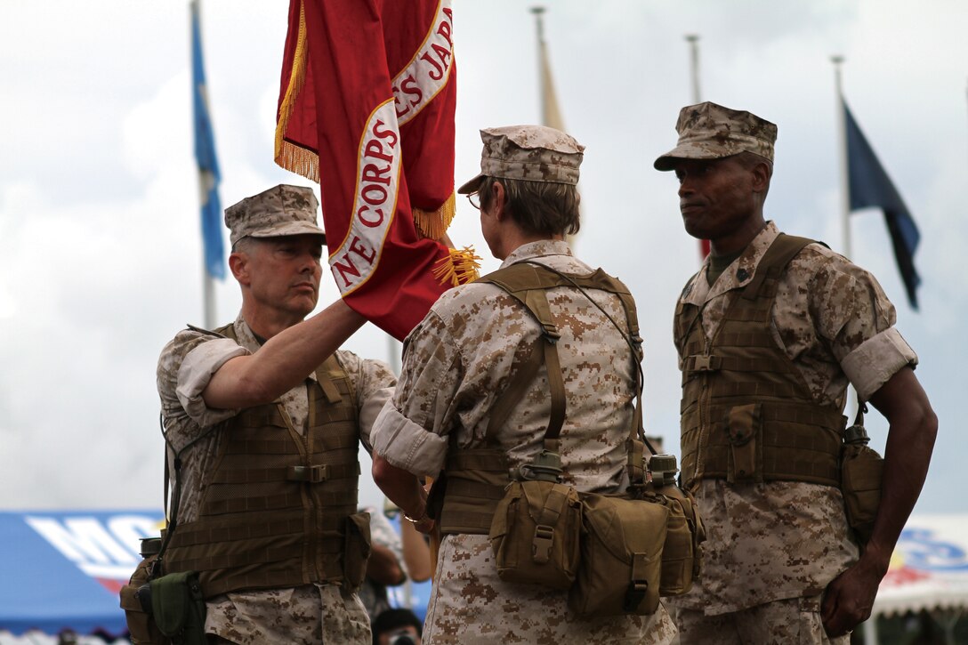 Maj. Gen. (select) Peter J. Talleri accepts command of Marine Corps Base Camp Smedley D. Butler from Maj. Gen. Mary Ann Krusa-Dossin July 23 during a change of command ceremony.::r::::n::