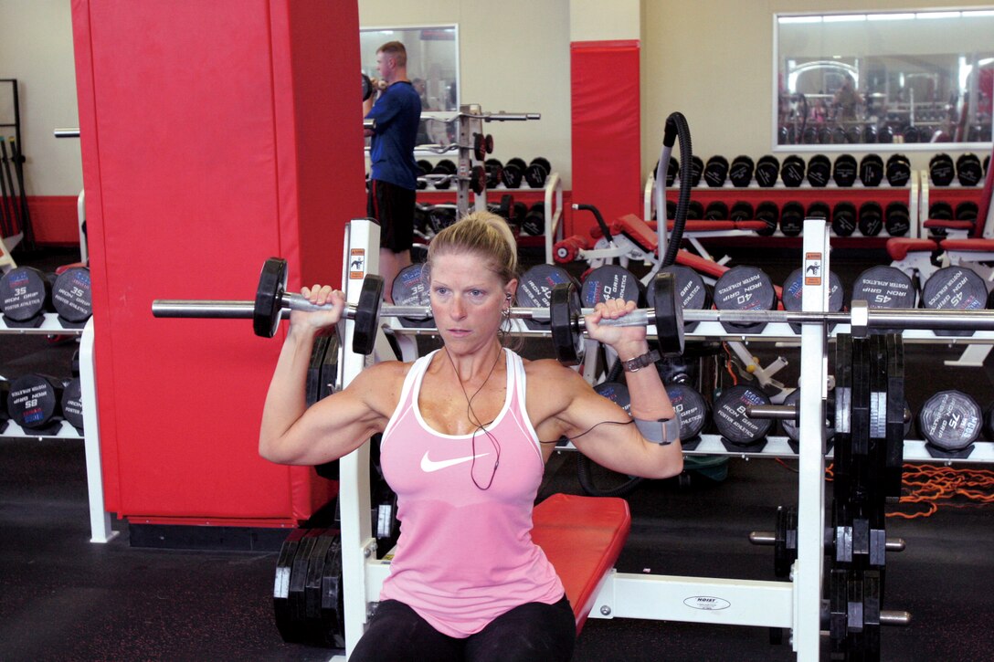 Erica Ortensie pumps iron in Gunners Gym July 23 in preparation for the 15th Annual Far East Bodybuilding Competition at the Camp Foster Theater Sunday.