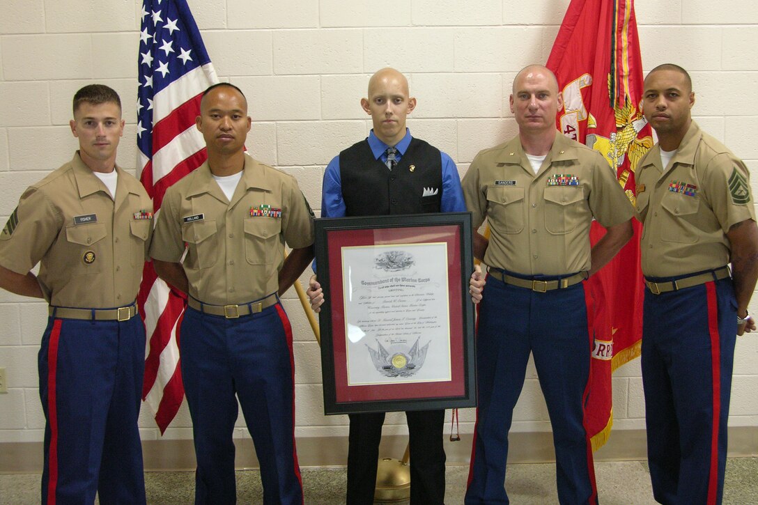 After being named an Honorary Marine July 23, Derrick Owen (center) stands with (left to right) Recruiting Sub-Station Newport News recruiters Sgt. Jared Fisher and Staff Sgt. Felimon Holland, Maj. Benjamin Sanders, the commanding officer of Recruiting Station Richmond, and Gunnery Sgt. Jermail Foster, the RSS Newport News staff non-commissioned officer in charge.  Owen was diagnosed with Rhabdomyosarcoma, a rare form of cancer that attacks tissue and bone, in January while waiting to graduate high school and attend Marine Corps Recruit Training.