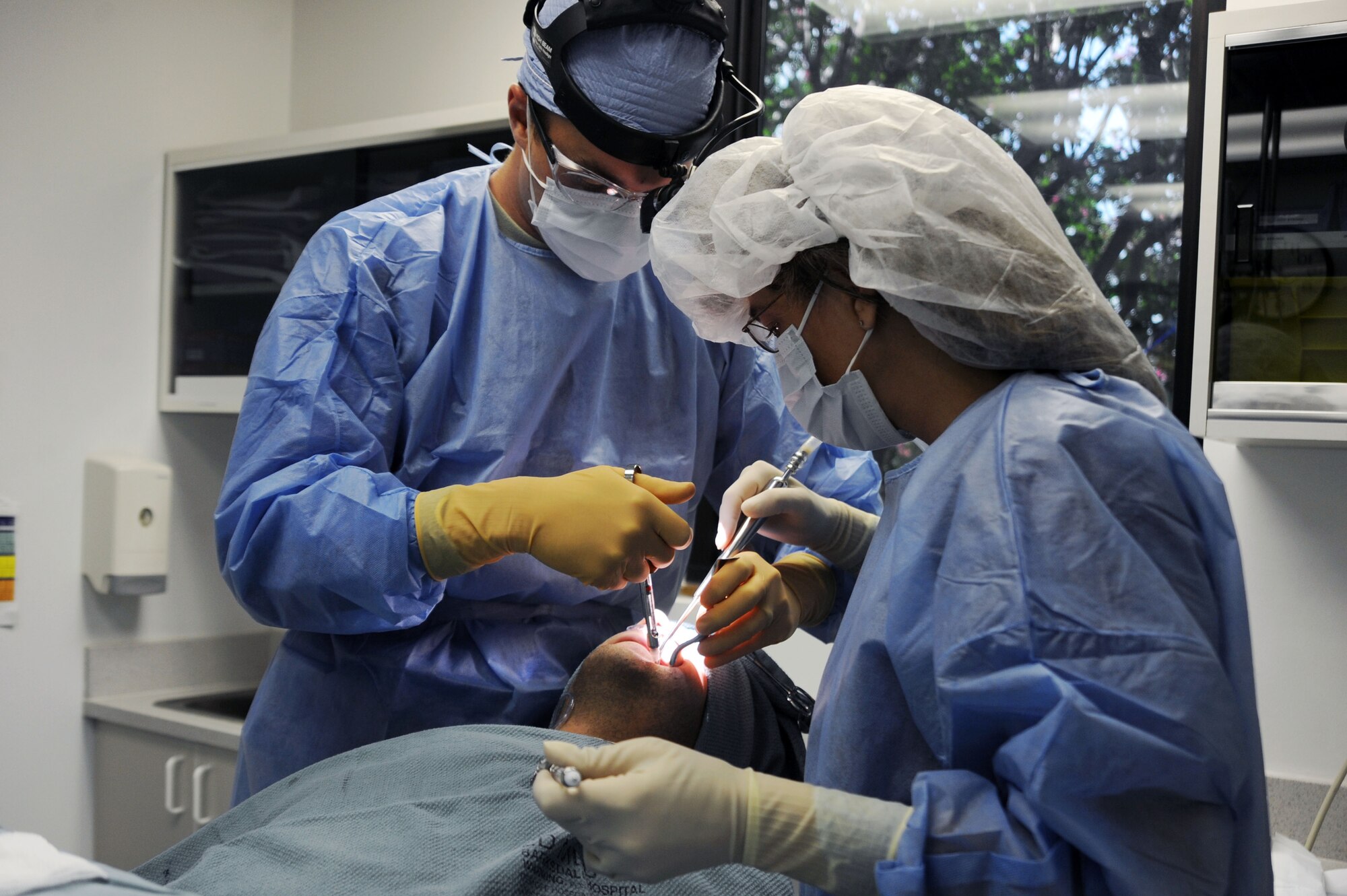 BARKSDALE AIR FORCE BASE, La. -- Joyce Coller, 2d Dental Squadron, dental assistant and Tech. Sgt. Richard McCain, 2d DS, dental logistics non-commissioned officer in charge, wraps impression in preparation for sterilization July 23. The dental clinic offers both general dentistry and special dental treatment for active-duty and family members (U.S. Air Force photo by Senior Airman Brittany Y. Bateman)(RELEASED)