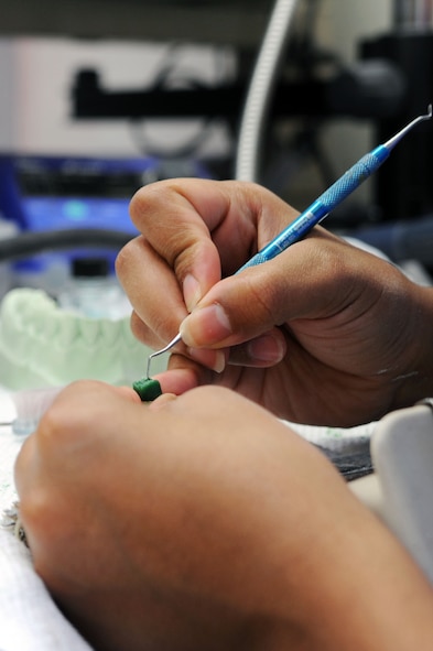 BARKSDALE AIR FORCE BASE, La. -- Staff Sgt. Felicia Chapko, 2d Dental Squadron, dental laboratory technician creates a wax ceramic mold of a patients crown tooth July 23. The 2d DS works and trains as a team to maintain a maximum state of readiness for any contingency while providing quality service to its internal and external customers. (U.S. Air Force photo by Senior Airman Brittany Y. Bateman)(RELEASED)