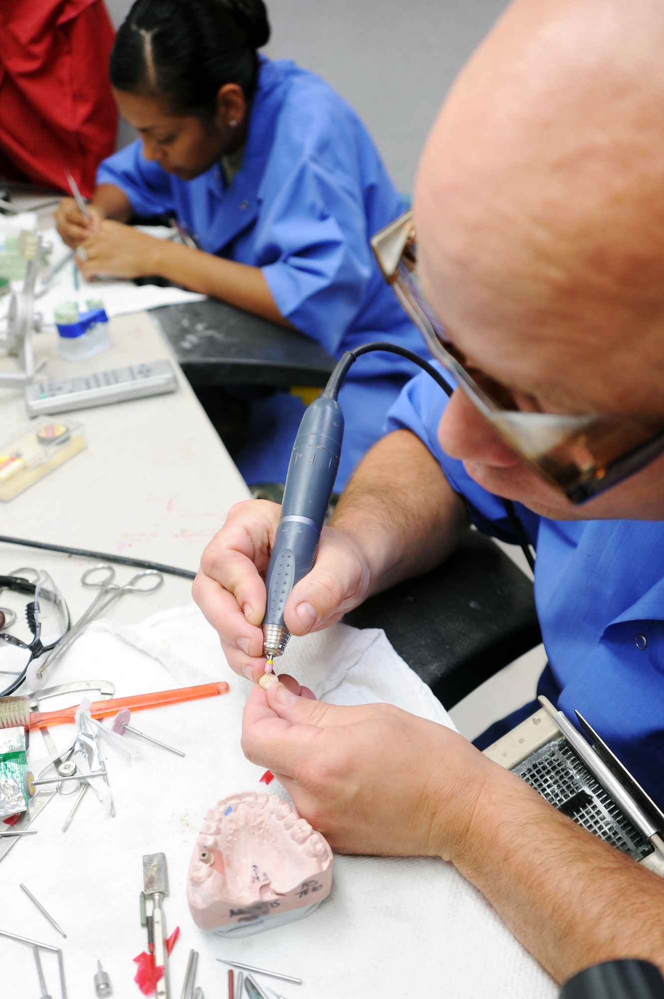 BARKSDALE AIR FORCE BASE, La. -- Tech. Sgt. William Fitzpatrick, 2d Dental Squadron, dental laboratory technician replaces a ceramic crown tooth for a patient July 23. The 2d Dental Squadron supports the readiness of the 2d Bomb Wing and associated units by ensuring the health of its community by providing optimal patient-focused dental care. (U.S. Air Force photo by Senior Airman Brittany Y. Bateman) (RELEASED)  