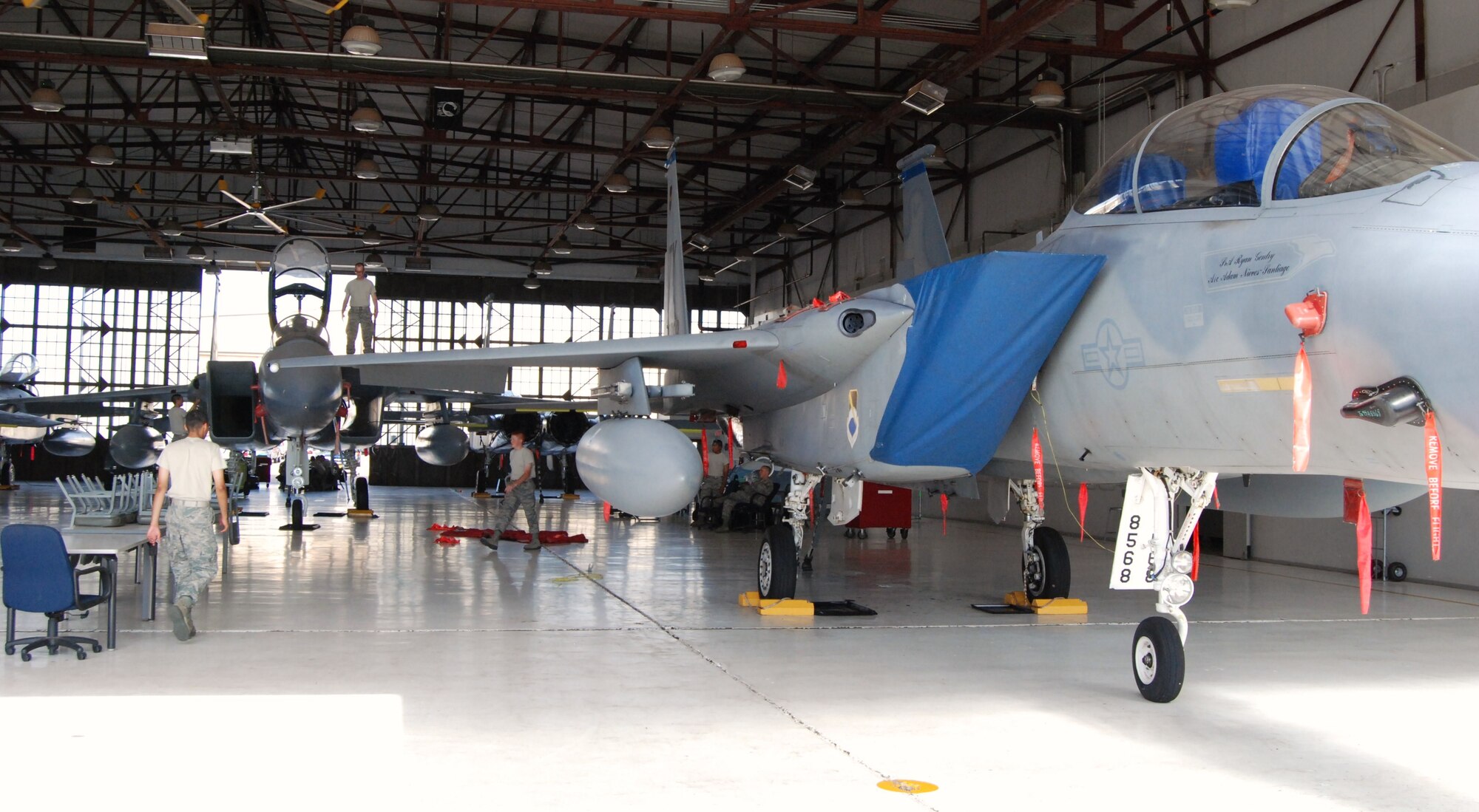 An F-15D (front) is parked in a training hangar at Sheppard Air Force Base, Texas, July 23 to be used for training F-15 aircraft maintenance students on the latest equipment and controls of an F-15 jet. Sheppard acquired a total of 13 F-15s which were converted into trainers to update F-15 maintenance courses that used F-15A and F-15B models, which do not match the models currently used on operational flightlines.  The newer-model aircraft is awaiting the arrival of technical orders before it can be used to instruct students.  (U.S. Air Force photo/Tech. Sgt. Vernon Cunningham)