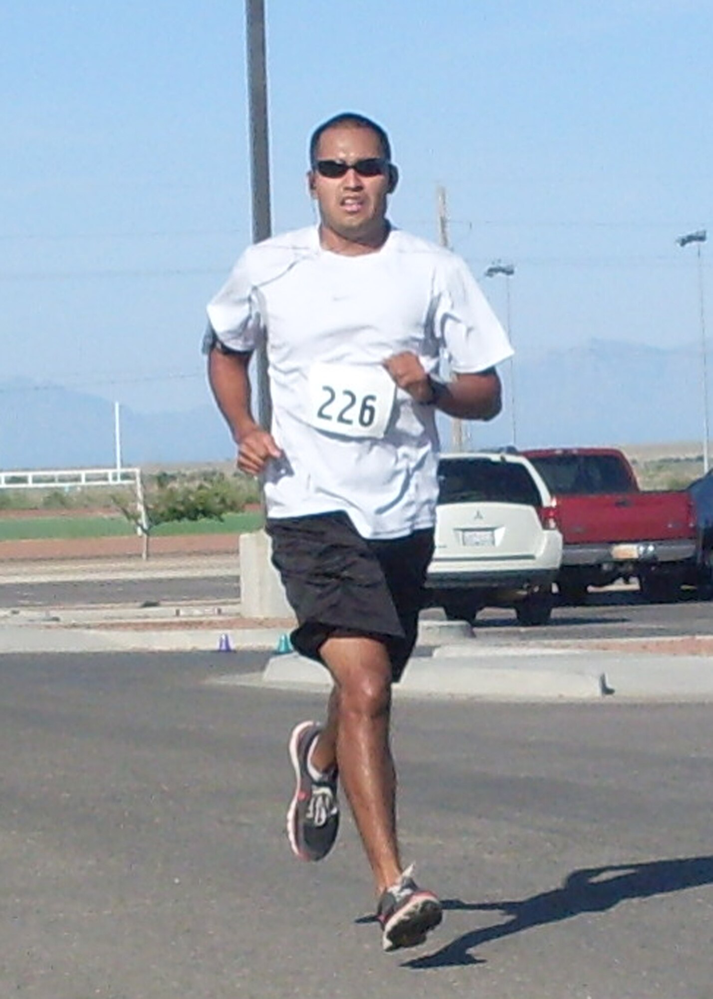 HOLLOMAN AIR FORCE BASE, N.M. -- 2nd Lt. Alejandro Carrera, 49th Attack Squadron, sprints to the finish line during the Half Marathon at the Domenici Fitness and Sports Center July 17, 2010. Lieutenant Carrera finished in second place in the men's category of the 13.2 mile race. (Courtesy photo) 