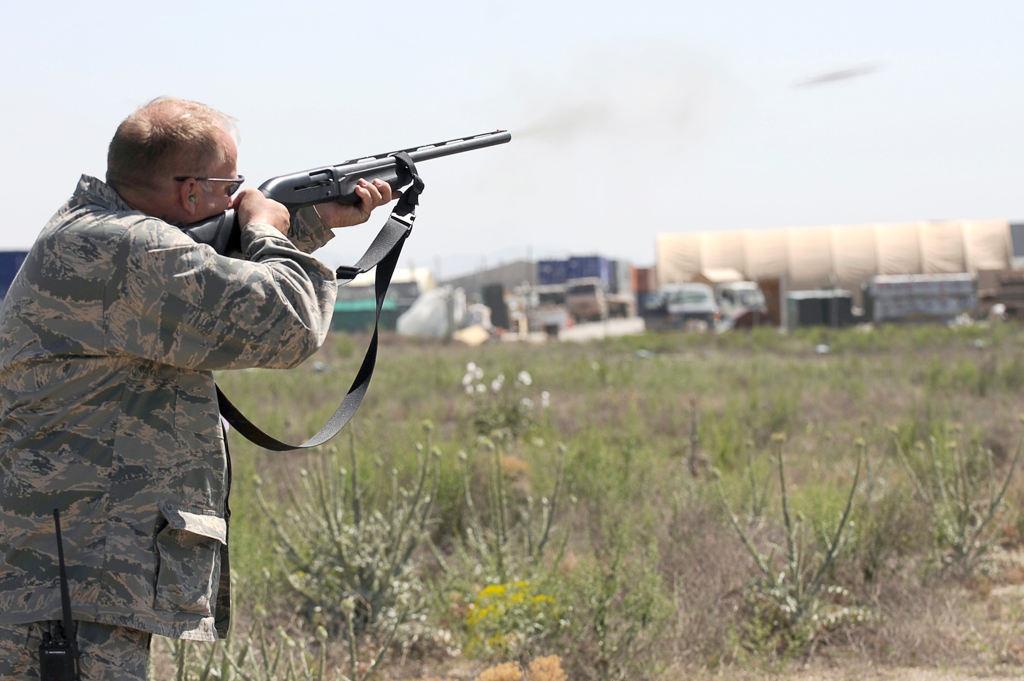 Todd Grimm fires his shotgun at birds flying near the flightline, May 20, 2010, at Bagram Airfield, Afghanistan. Mr. Grimm is a wildlife biologist with the U.S. Department of Agriculture, Wildlife Service program, working with the 455th Air Expeditionary Wing Safety Office to keep wildlife from interfering with flying operations. (U.S. Air Force photo/Master Sgt. Jeromy K. Cross) 