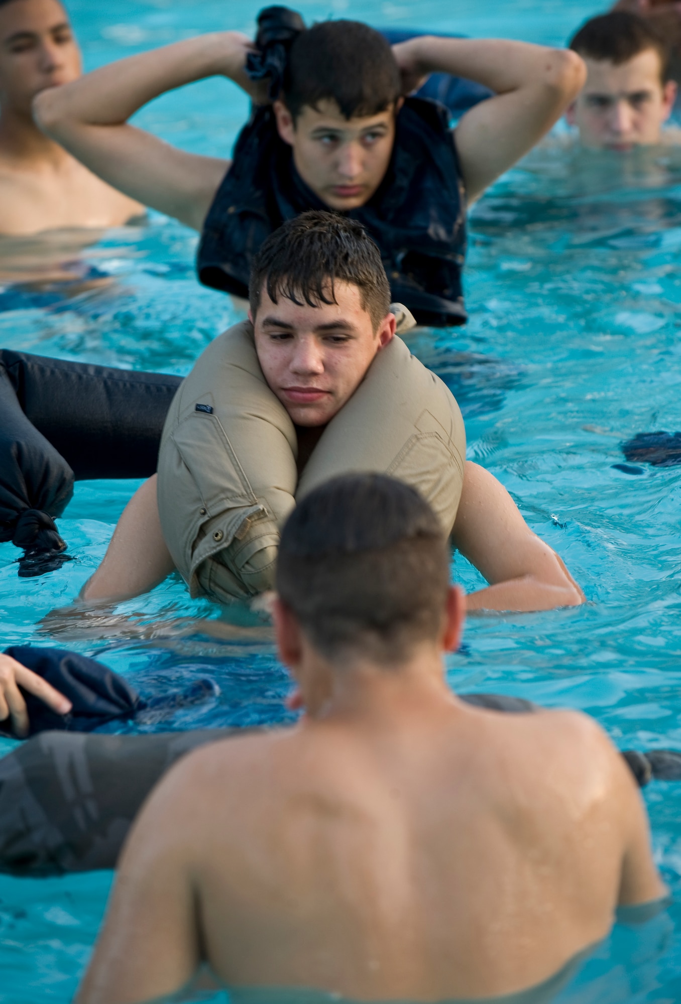 BARKSDALE AIR FORCE BASE, La. -- Civil Air Patrol cadets practice using a pair of pants as an improvised floatation device during a water survival course hosted by the 2d Operations Support Squadron Survival, Evasion, Resistance and Escape specialists July 21. The course was part of the annual CAP Louisiana Wing Cadet Encampment held here from July 15-25. (U.S. Air Force photo by Senior Airman Chad Warren) (RELEASED)